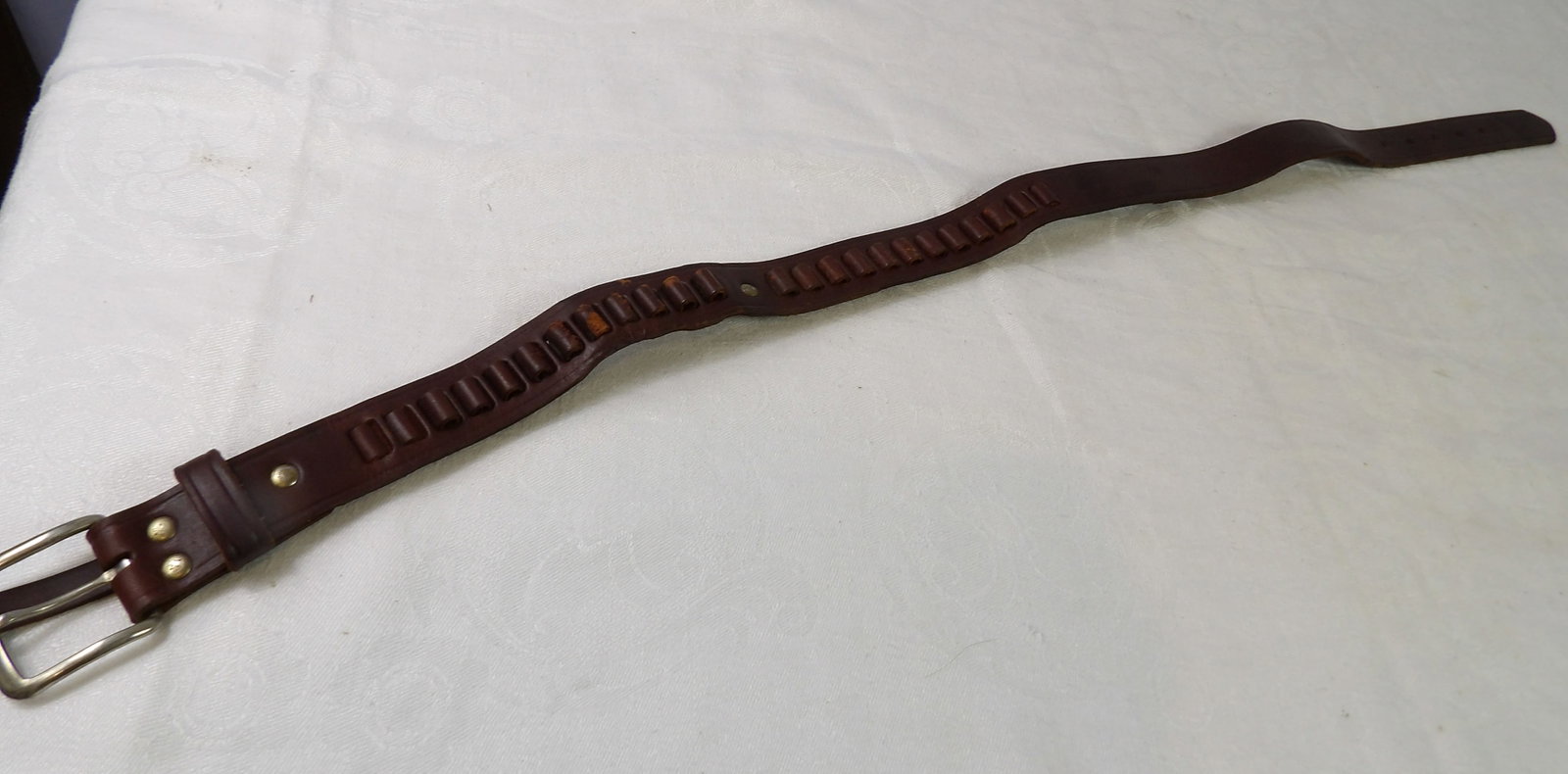 Youth Size Gun Belt: 32" Youth Size Leather Gun Belt, made by Bucheimer. All measurements approximate. Please see photos for condition and details. Selling as is from 04281.