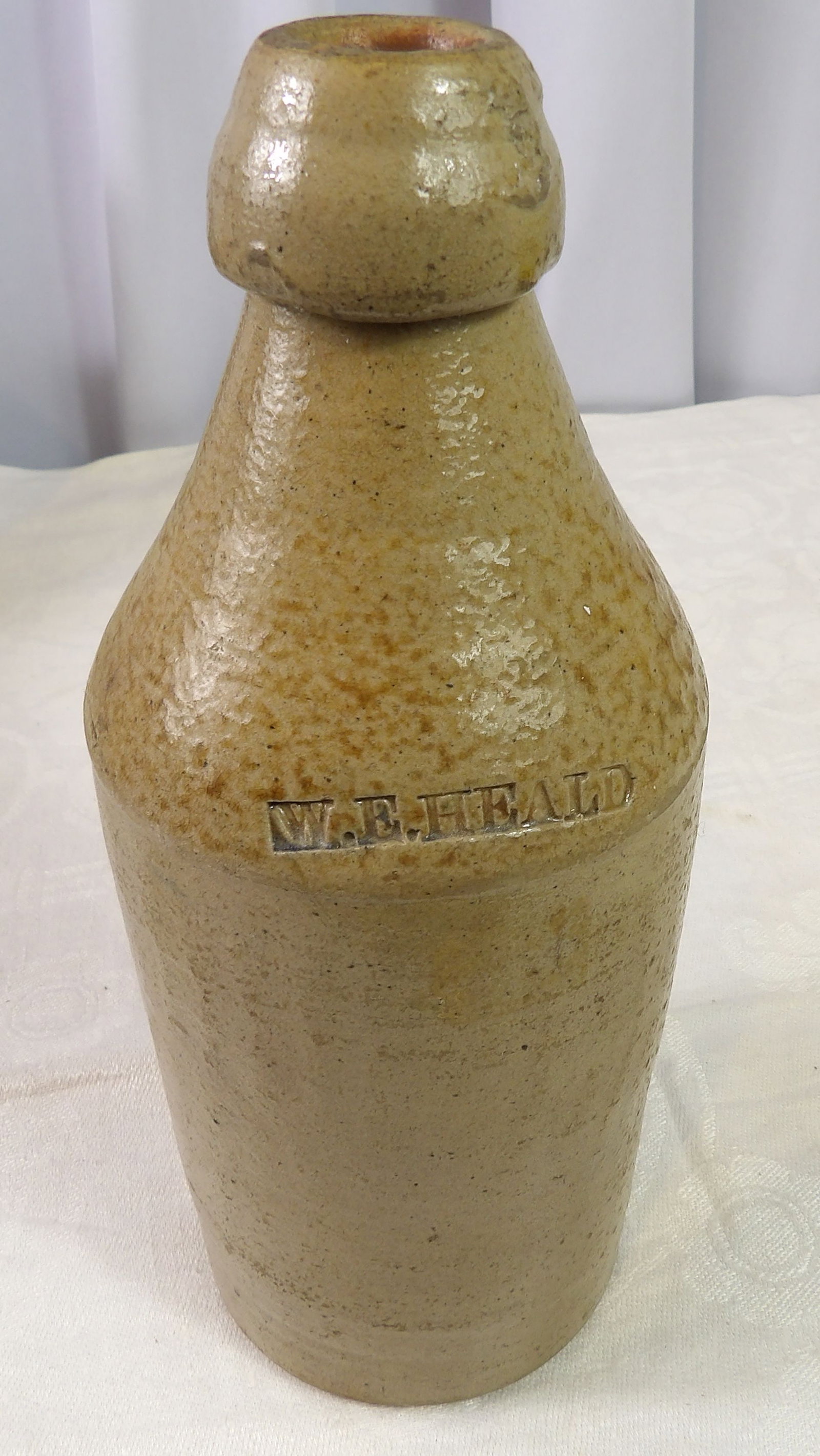 W.E. Heald Stoneware Bottle: W.E. Heald Vintage Stoneware Bottle. All measurements approximate. Please see photos for condition and details. Selling as is from 04281.