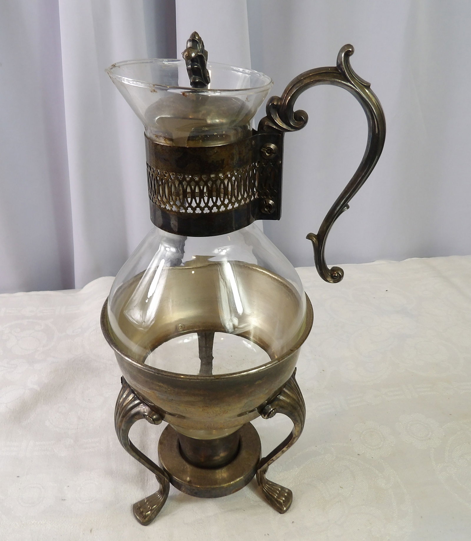 Vintage Coffee/Tea Carafe: Vintage Glass Coffee/Tea Carafe with Silver Plated Stand and Warmer. All measurements approximate. Please see photos for condition and details. Selling as is from 04281.