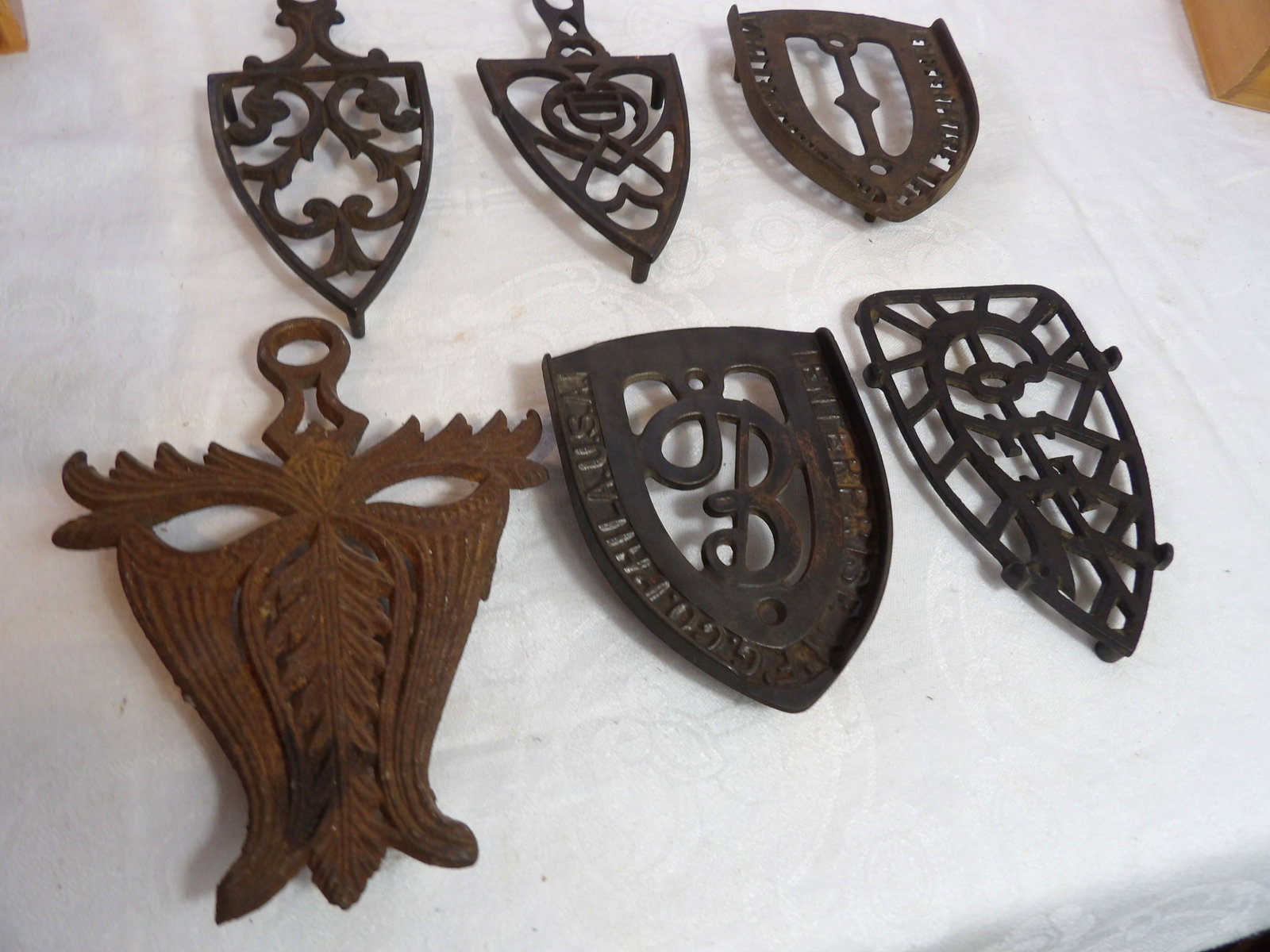 6 PCS.-Cast Iron Trivets: Set of 6 Cast Iron Trivets. All measurements approximate. Please see photos for condition and details. Selling as is from 04281.