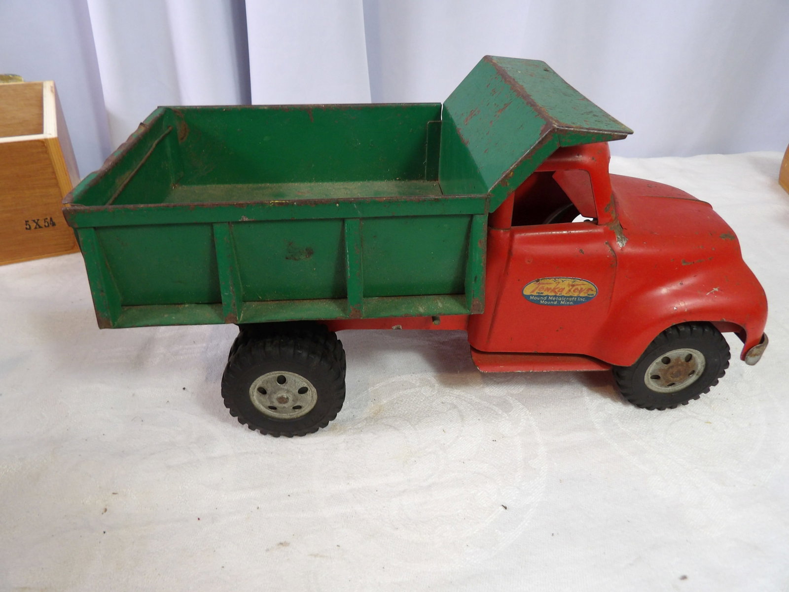 Vintage Tonka Dump Truck: Vintage Tonka Pressed Steel, Red and Green Dump Truck. All measurements approximate. Please see photos for condition and details. Selling as is from 04281.