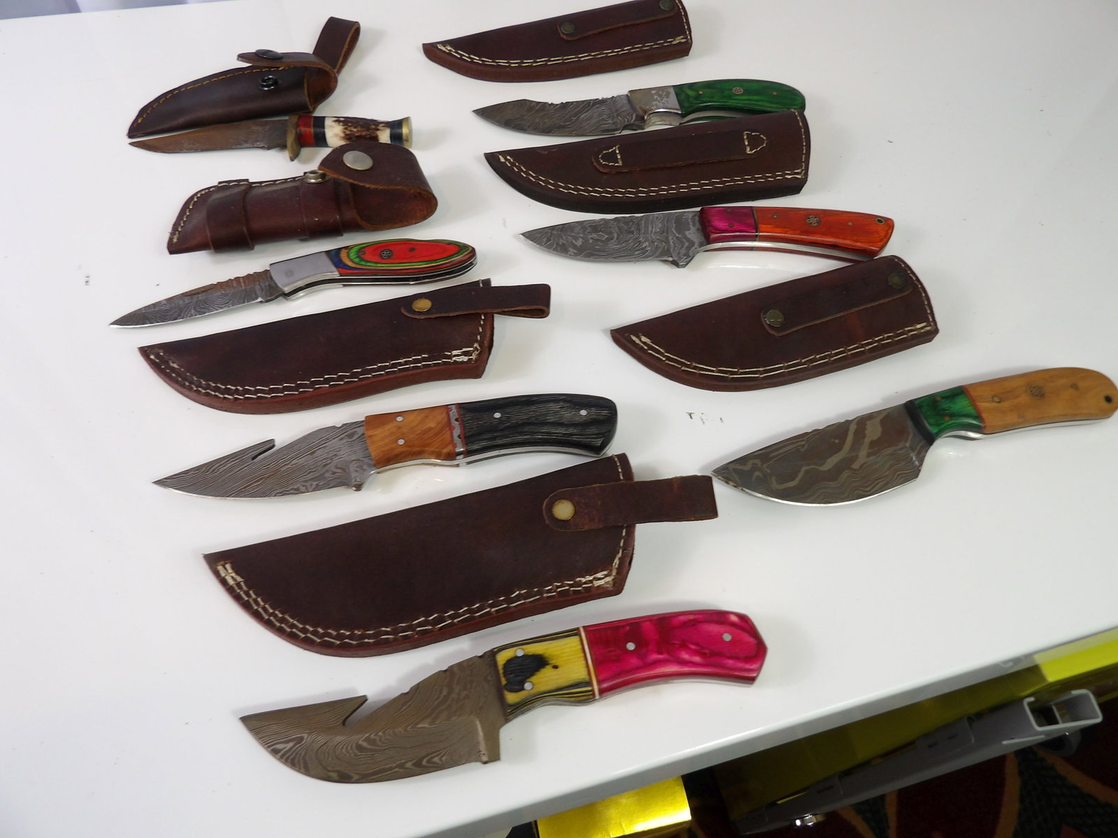 7 PCS.-Damascus Blades with Sheaths: 7 Handmade Damascus Steel Blades with Leather Sheaths. All measurements approximate. Please see photos for condition and details. Selling as is from 04281.