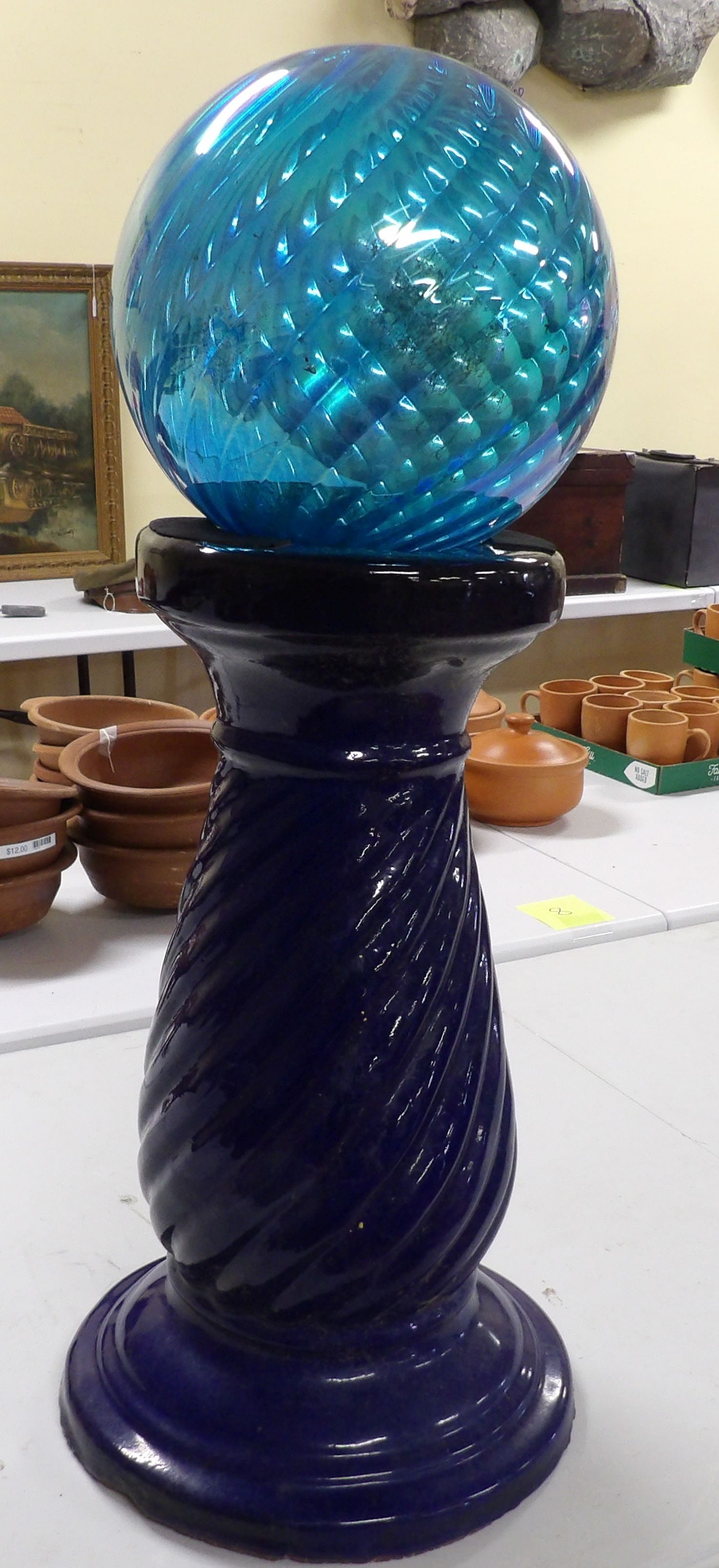 Glass Ball on Pedestal: Blue Iridescent Glass Ball on Heavy Twisted Ceramic Pedestal, 29" Tall. All measurements approximate. Please see photos for condition and details. Selling as is from 04281.