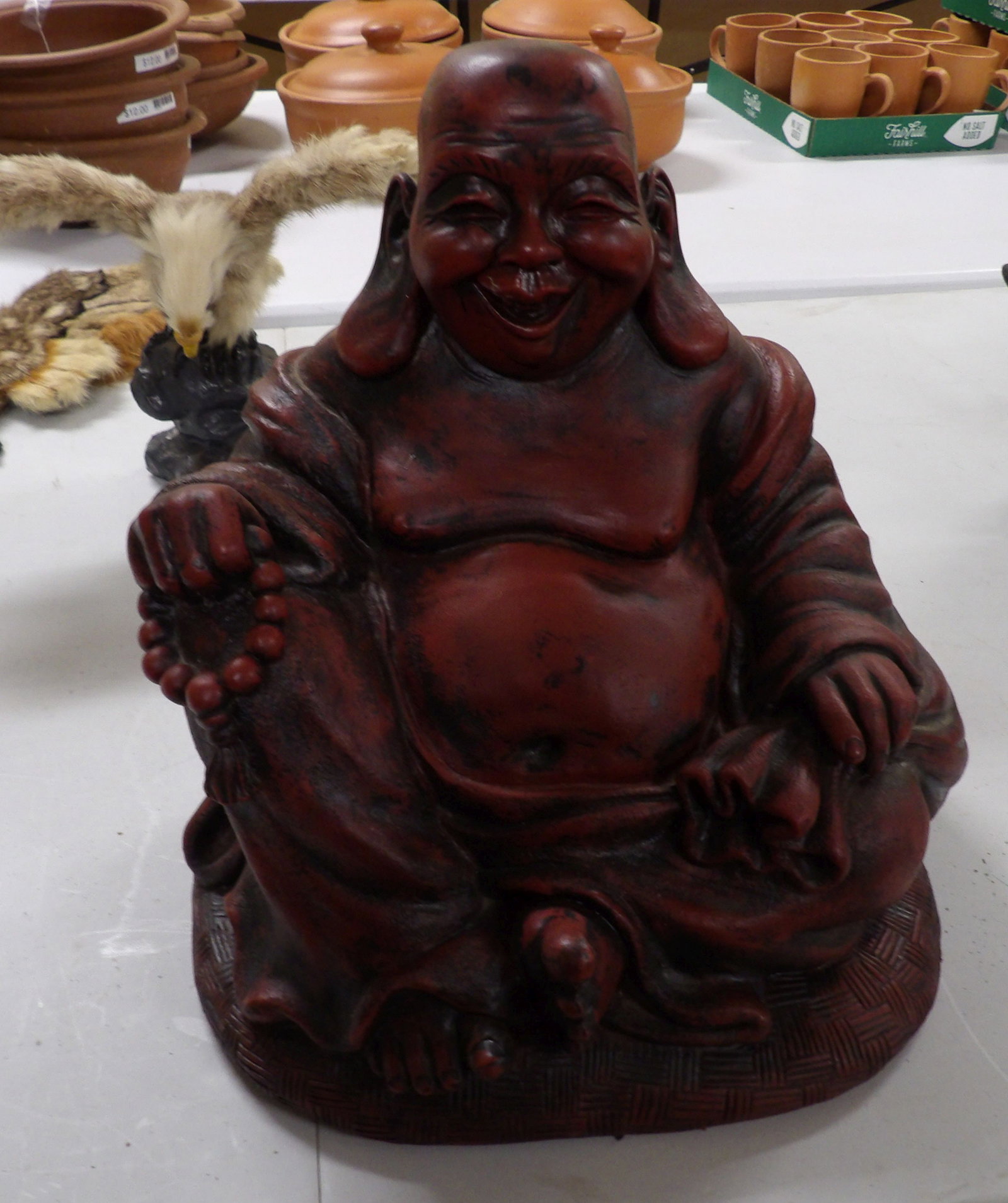12" Seated Buddha: 12" Tall Seated Laughing Buddha, Rosewood Color. All measurements approximate. Please see photos for condition and details. Selling as is from 04281.