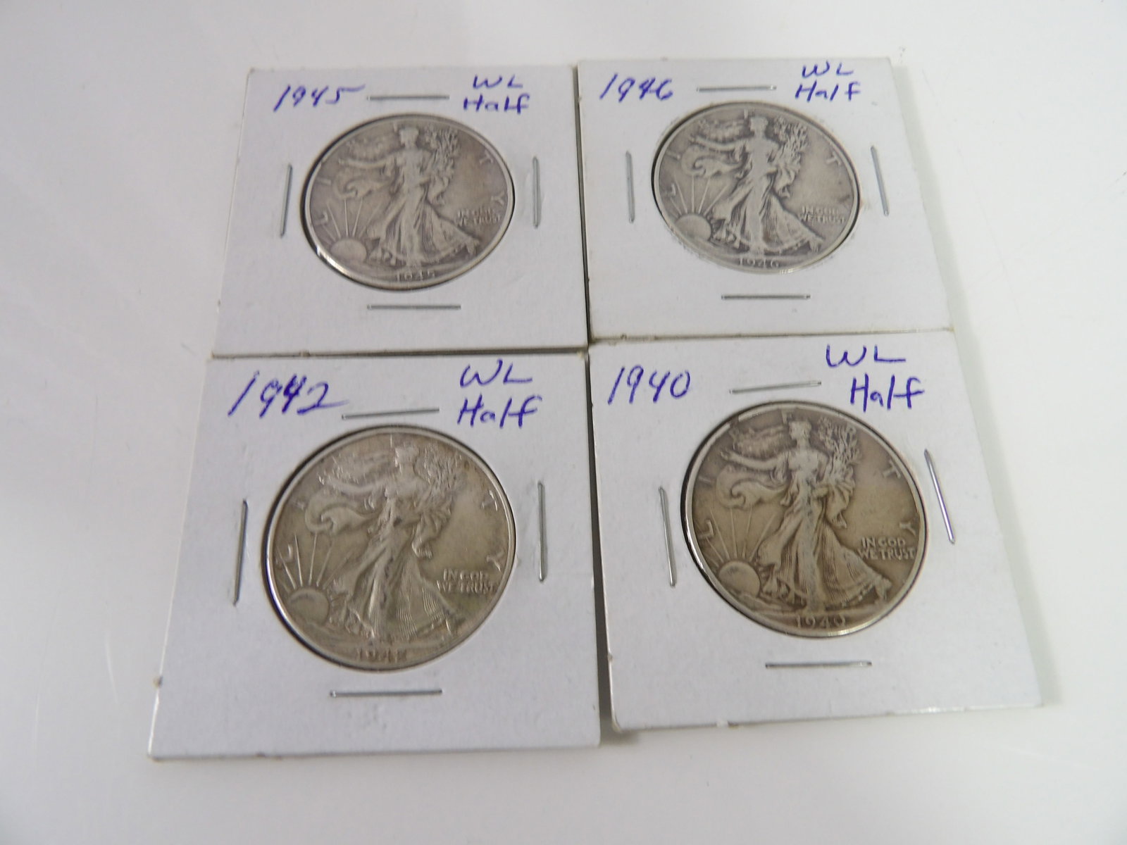 4 1940's Walking Liberty Half Dollars: Set of 4, 1940's Walking Liberty Half-Dollars. All measurements approximate. Please see photos for condition and details. Selling as is from 04281.