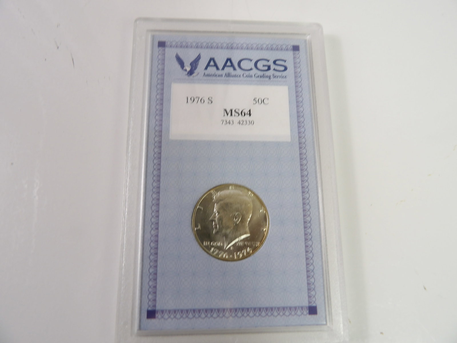 1976S Kennedy Half-Dollar, Slabbed & Graded by American Alliance Coin Grading Service: 1976S Kennedy Half Dollar, Graded MS64 by American Alliance Coin Grading Service. All measurements approximate. Please see photos for condition and details. Selling as is from 04281.