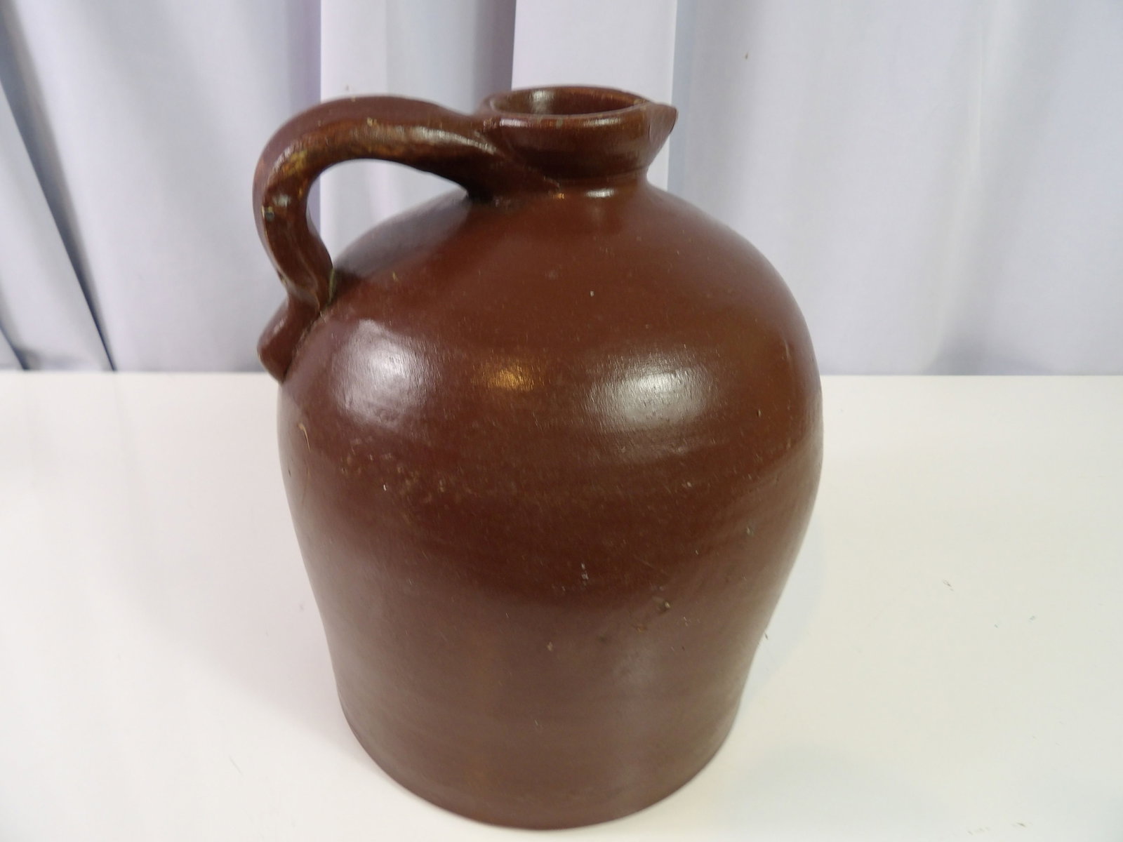 Glazed Stoneware Jug: Brown Glazed Stoneware Jug with Handle and Spout. Great Condition. All measurements approximate. Please see photos for condition and details. Selling as is from 04281.