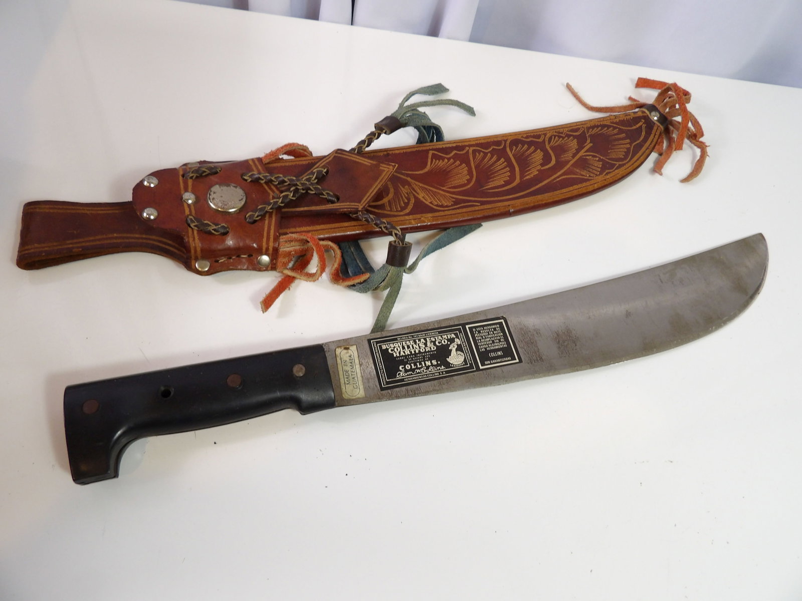 Vintage Collins & Co. Machete with Leather Sheath: Vintage Collins & Co. Machete with Ornate Leather Sheath. All measurements approximate. Please see photos for condition and details. Selling as is from 04281.