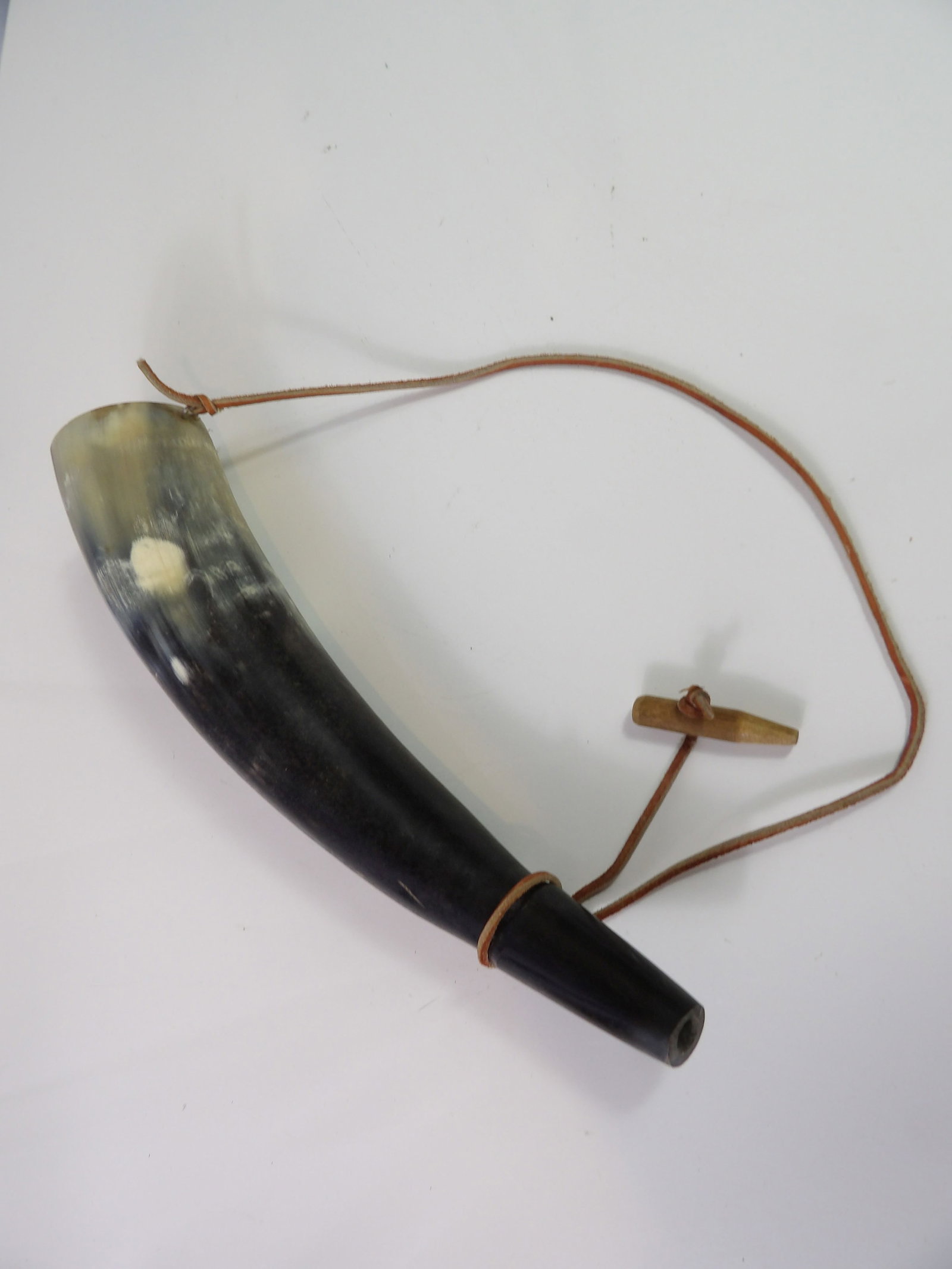 Vintage Powder Horn: Vintage Powder Horn with Wooden Stopper and Leather Strap. All measurements approximate. Please see photos for condition and details. Selling as is from 04281.