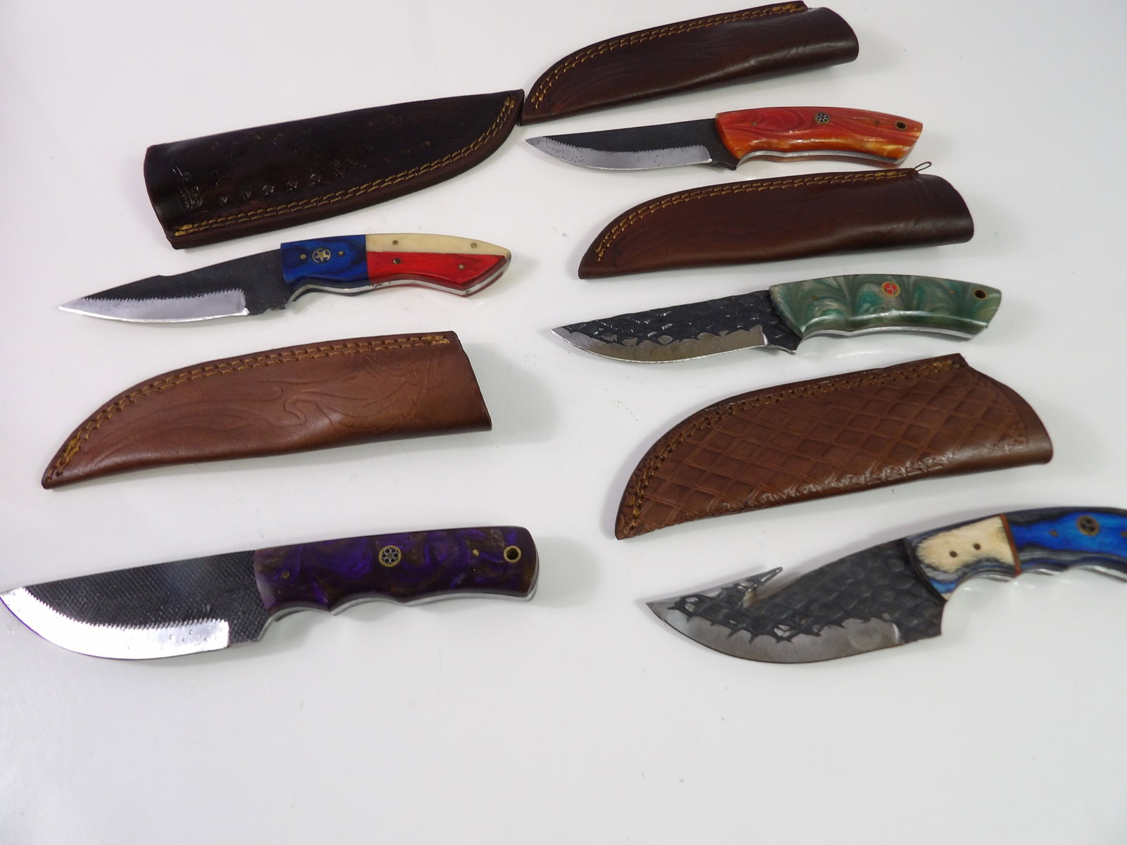 5 Handmade Damascus Steel Knives with Sheaths: Lot of 5 New Handmade Damascus Steel Knives with Leather Sheaths. All measurements approximate. Please see photos for condition and details. Selling as is from 04281.