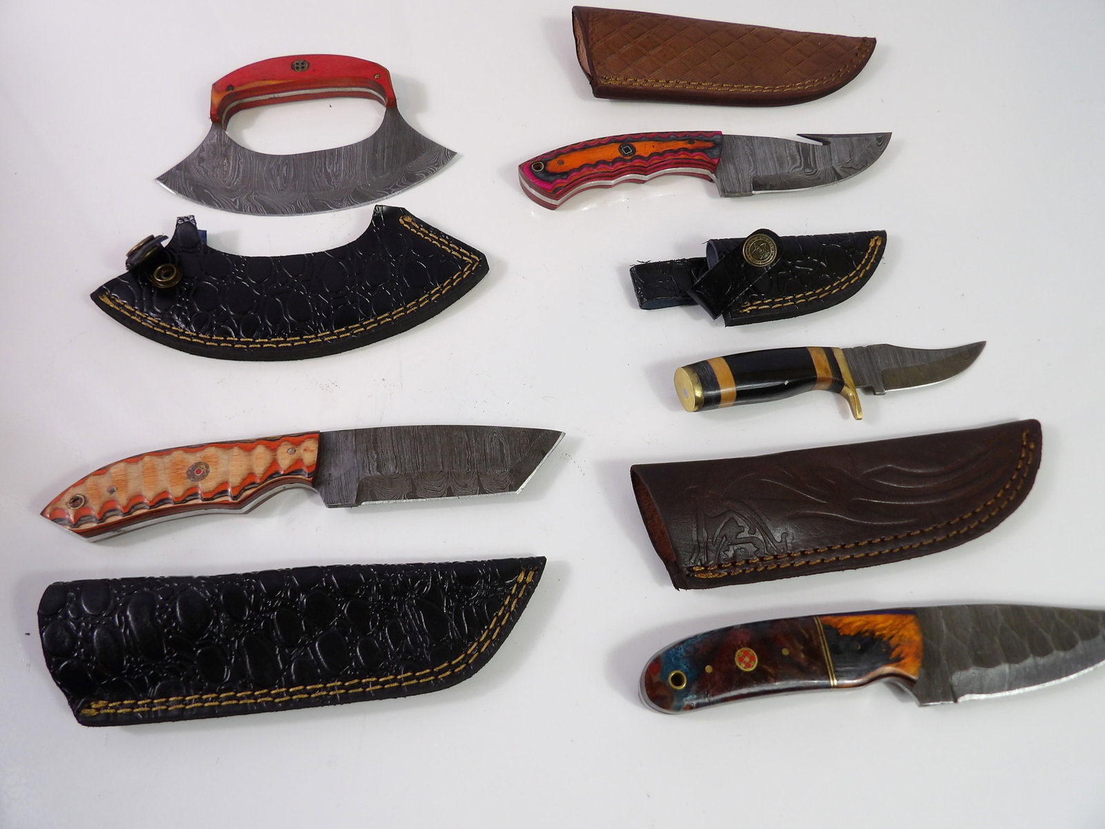 5 Handmade Damascus Steel Knives With Sheaths: Lot of 5 New Handmade Damascus Steel Knives with Leather Sheaths. All measurements approximate. Please see photos for condition and details. Selling as is from 04281.