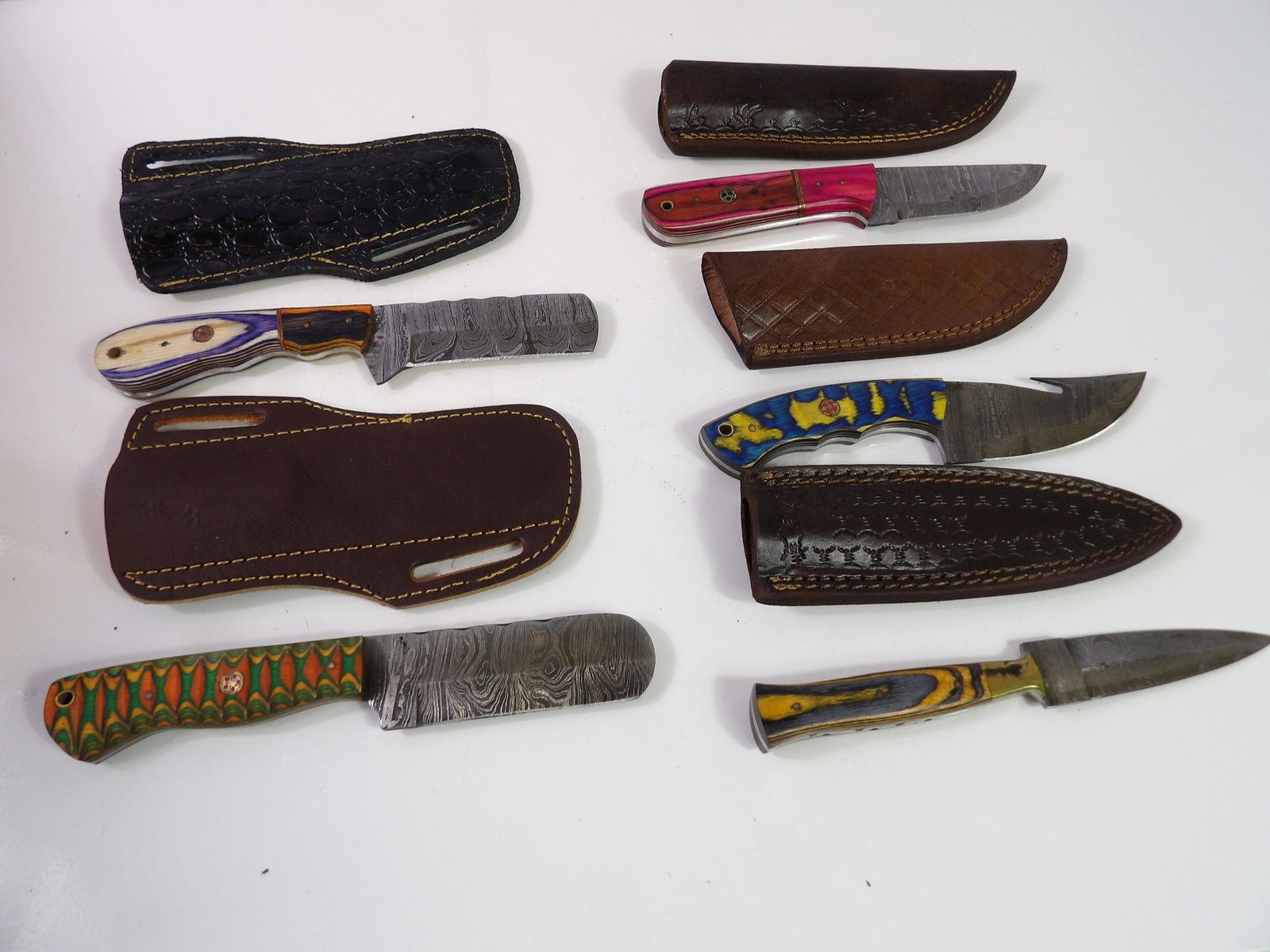 5 Handmade Damascus Steel Knives With Sheaths: Lot of 5 New Handmade Damascus Steel Knives with Leather Sheaths. All measurements approximate. Please see photos for condition and details. Selling as is from 04281.