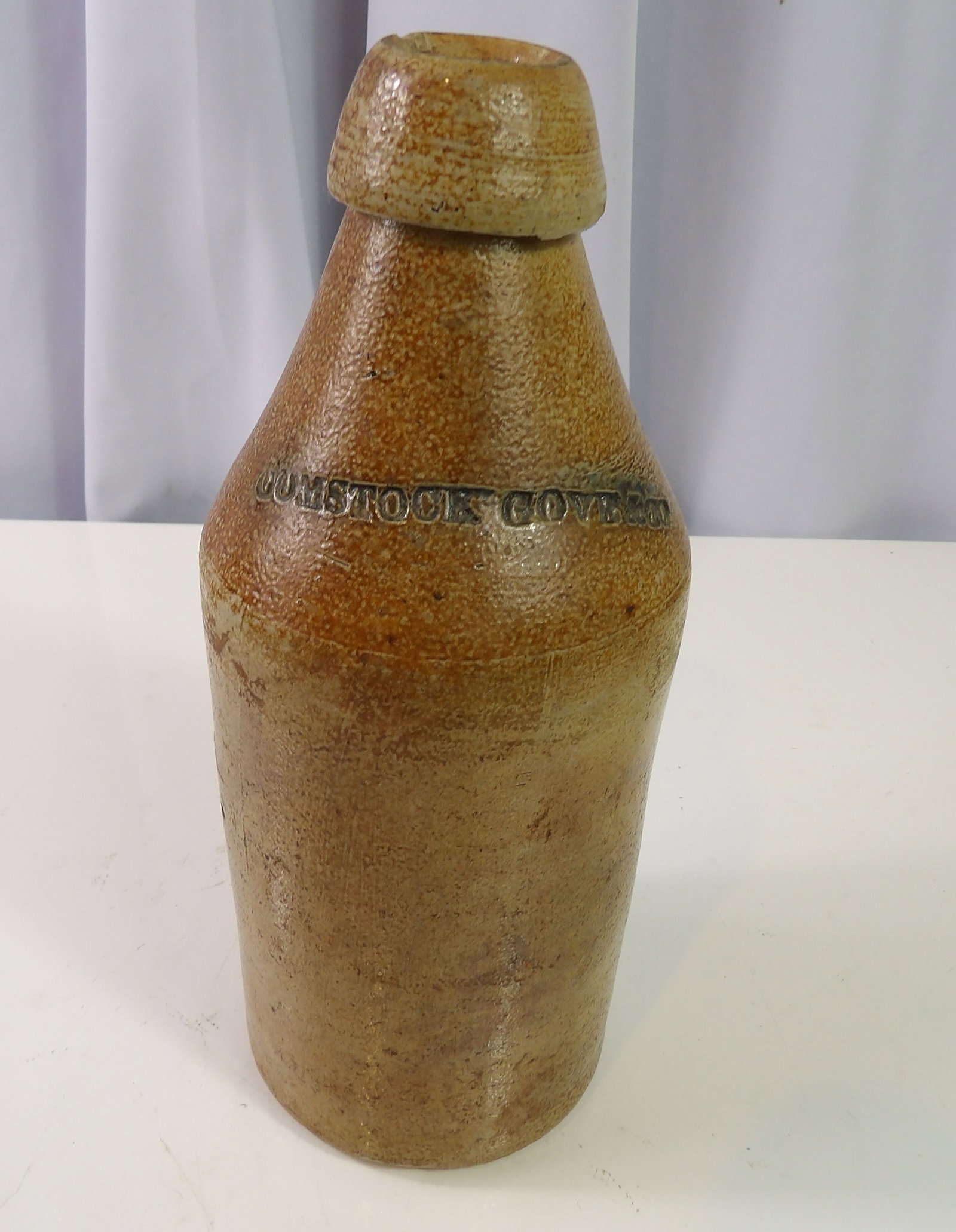 19th Century Salt Glazed Stoneware Bottle Inscribed Comstock Gove & Co: Antique 19th Century Salt Glazed Stoneware Bottle, Inscribed Comstock Gove & Co. All measurements approximate. Please see photos for condition and details. Selling as is from 04281.