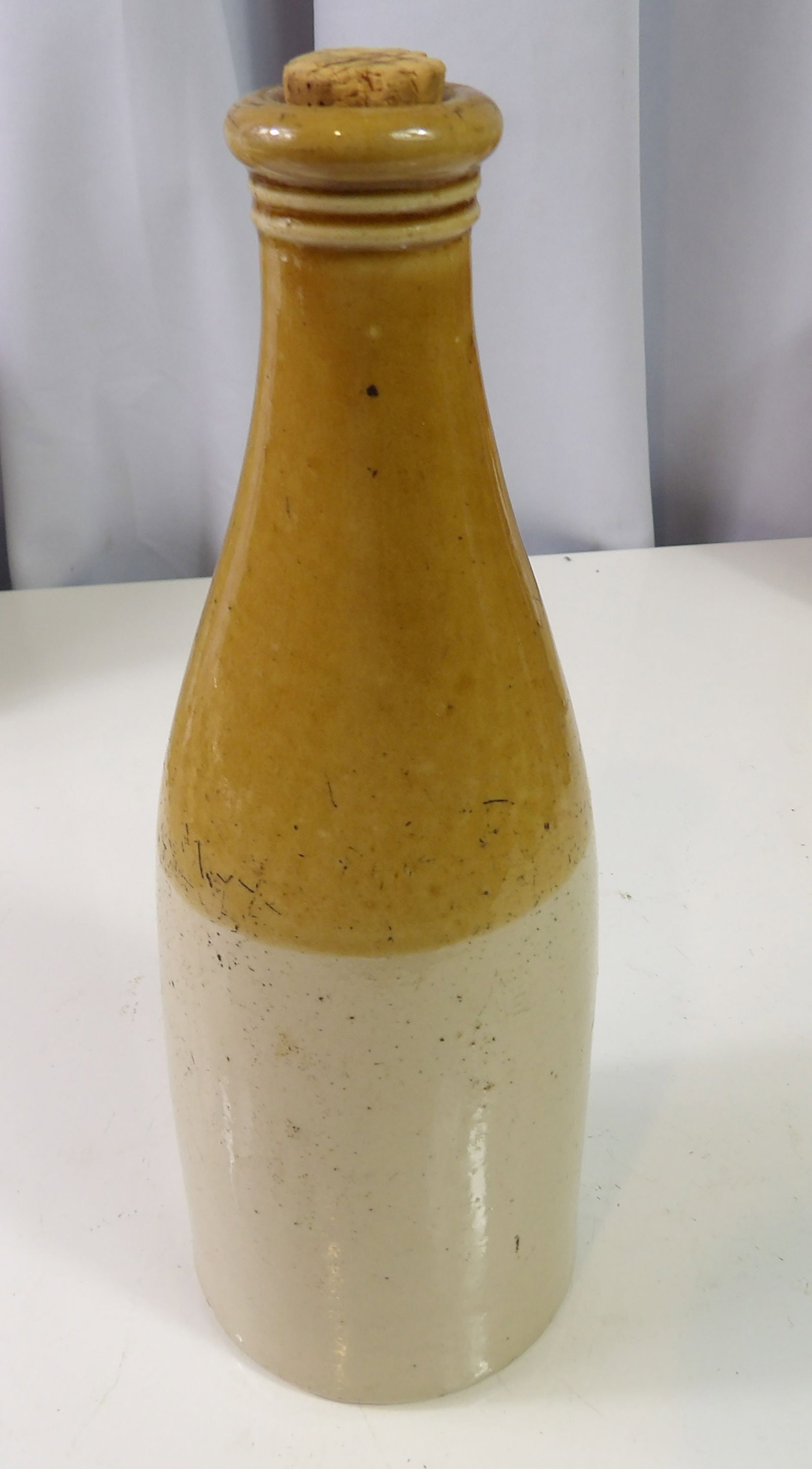 Two Tone Stoneware Ginger Beer Bottle: Antique Two Tone Stoneware Ginger Beer Bottle. All measurements approximate. Please see photos for condition and details. Selling as is from 04281.