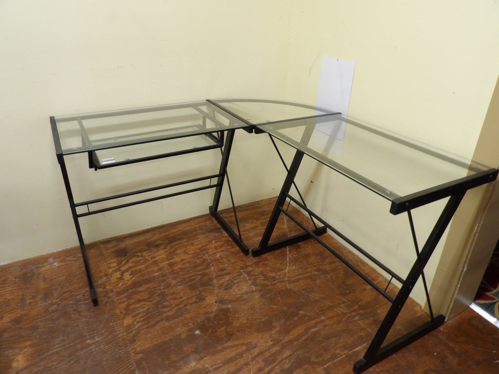 L-Shaped Metal & Glass Corner Computer Desk: L-Shaped Black Metal and Glass Corner Computer Desk. All measurements approximate. Please see photos for condition and details. Selling as is from 04281.
