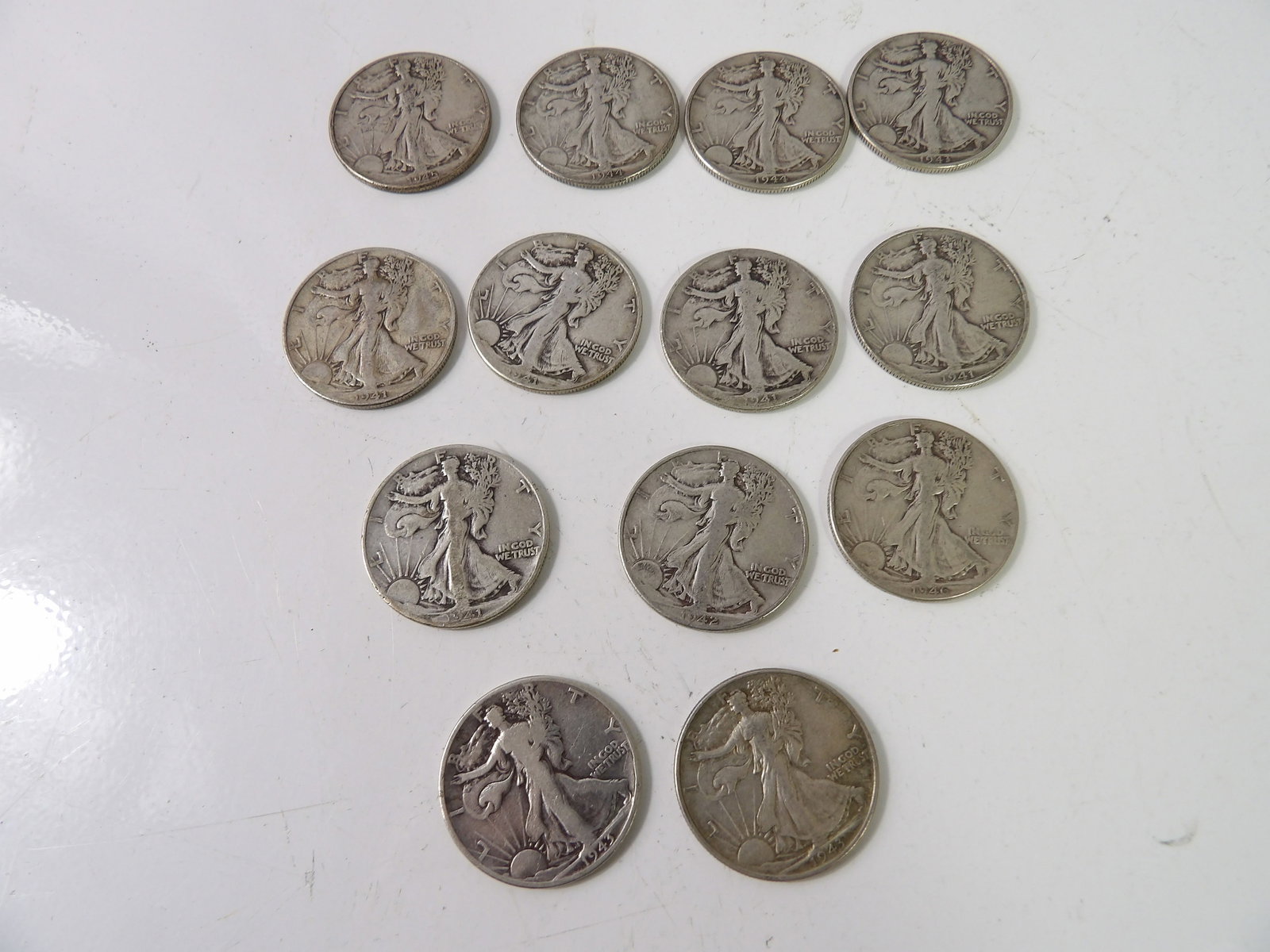 13 PCS.- Walking Liberty Half-Dollars: Lot of 13 Walking Liberty Half-Dollars. All measurements approximate. Please see photos for condition and details. Selling as is from 04281.
