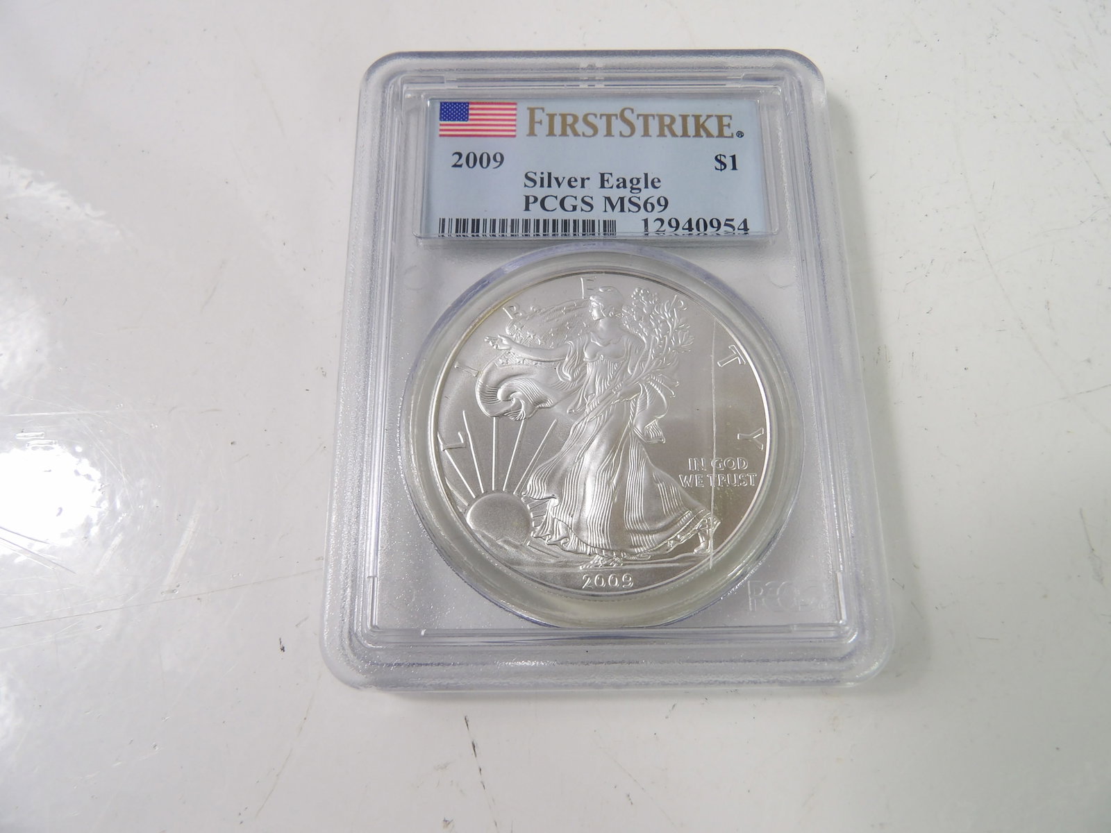 2009 Silver Eagle Bullion, First Strike, Slabbed & Graded by PCGS: 2009 Silver Eagle First Strike, MS69. Slabbed & Graded by PCGS. All measurements approximate. Please see photos for condition and details. Selling as is from 04281.