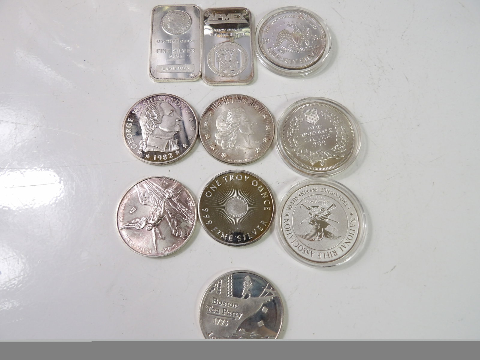 10 1 Troy Oz. Pure Silver Rounds: Lot of 10, 1 Troy Oz. Pure Silver Rounds and Ingots. All measurements approximate. Please see photos for condition and details. Selling as is from 04281.