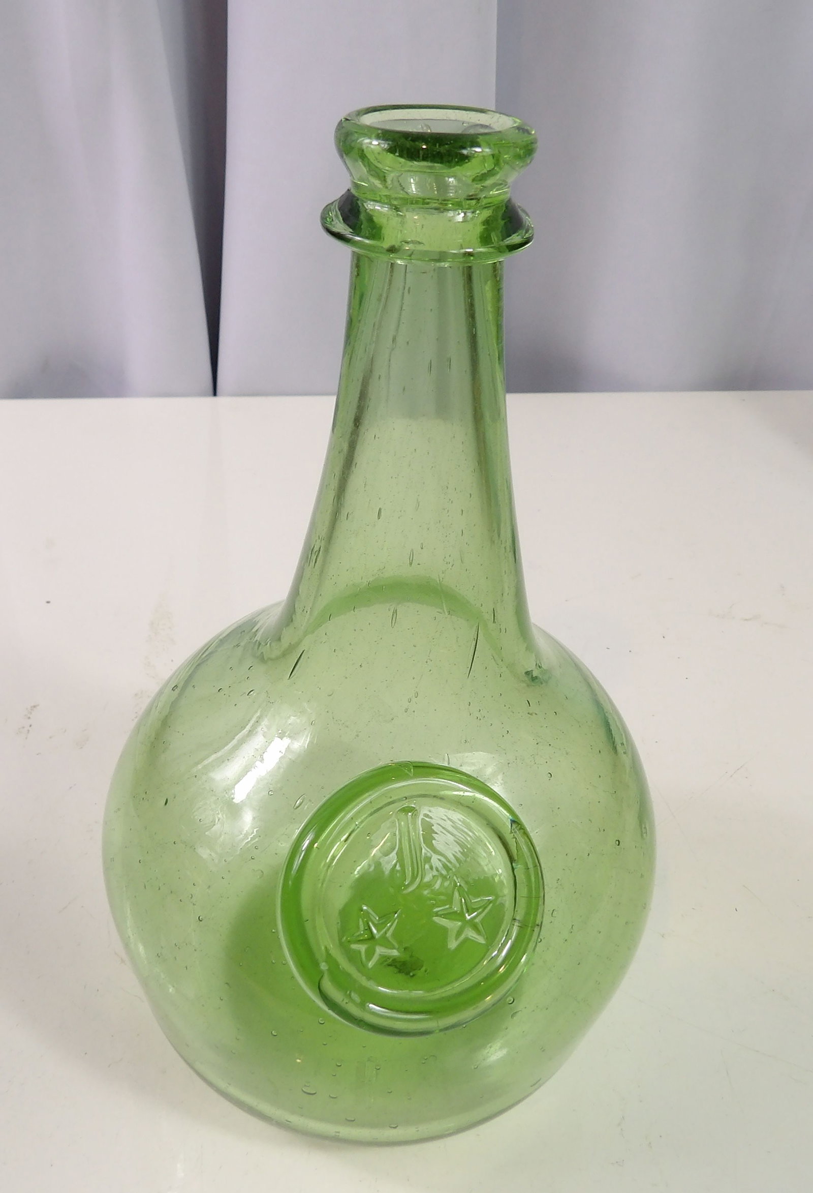 Vintage Wheaton Green Glass Bottle: Vintage Wheaton Green Glass Bottle with J and Stars Seal. All measurements approximate. Please see photos for condition and details. Selling as is from 04281.