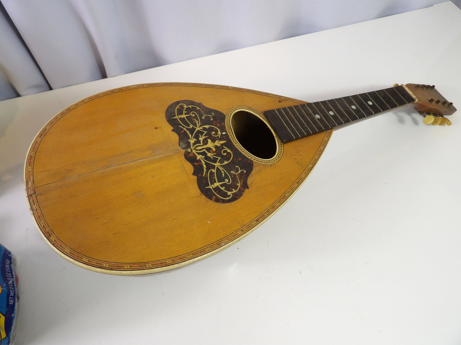 Vintage Bowlback Mandolin: Vintge Bowlback Mandolin with Ornate Pickguard Inlay. 23" Long. All measurements approximate. Please see photos for condition and details. Selling as is from 04281.