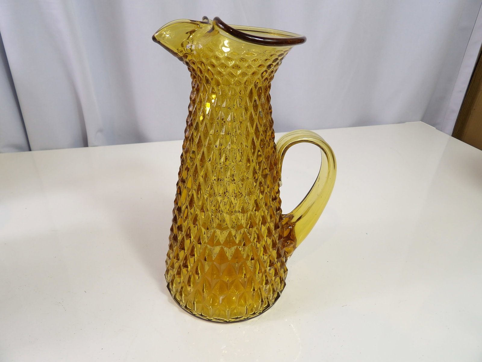 Vintage Amber Glass Pitcher: Vintage Amber Glass Diamond Point Pitcher with Applied Handle, 9" Tall, Pristine Condition. All measurements approximate. Please see photos for condition and details. Selling as is from 04281.
