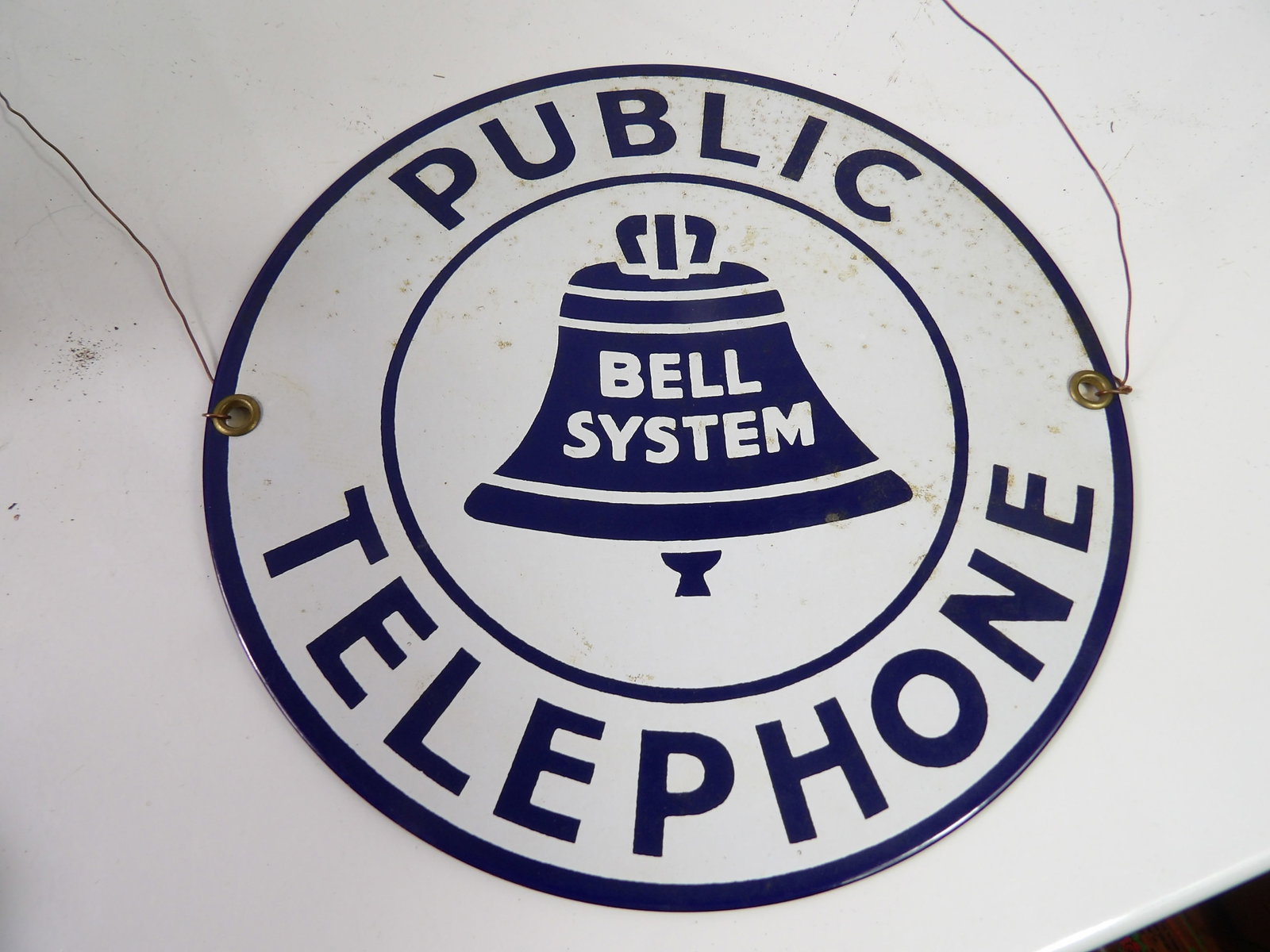 Vintage Round Porcelain/Enamel Bell System Telephone Sign: Vintage Round Bell System Public Telephone Sign, Porcelain/Enamel, Ande Rooney, 7" Diameter. All measurements approximate. Please see photos for condition and details. Selling as is from 04281.