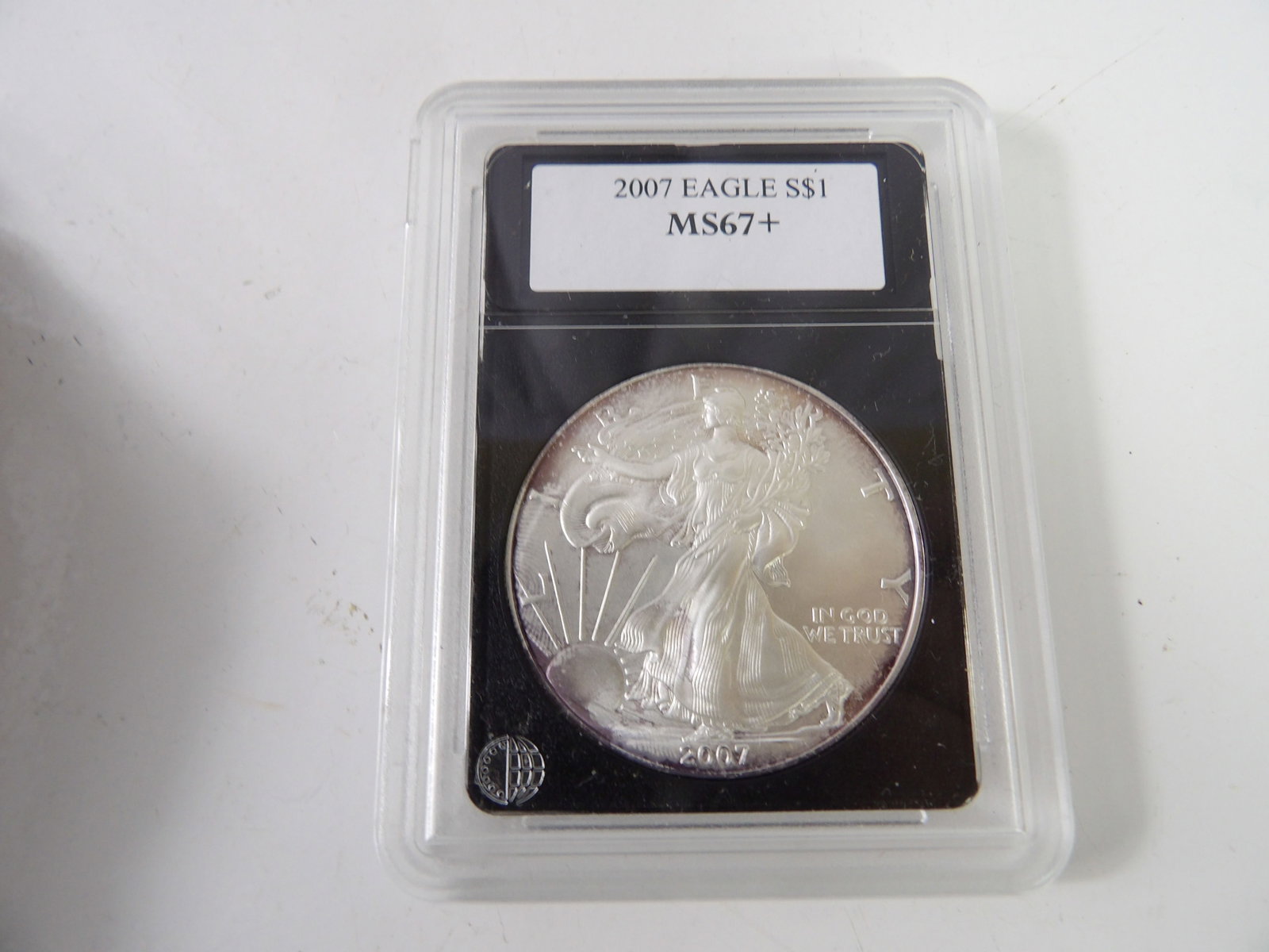 2007 Silver Eagle Bullion, Slabbed & Graded by Paramount Rare Coin & Currency: 2007 Silver Eagle, MS67+. Slabbed & Graded by Paramount Rare Coin & Currency. All measurements approximate. Please see photos for condition and details. Selling as is from 04281.