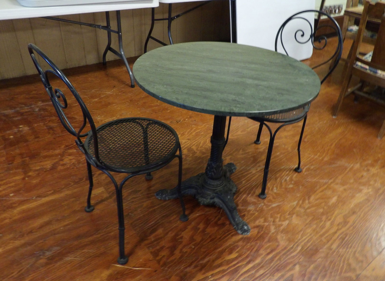 Vintage Bistro Table: Vintage Green Marble Top Bistro Table with Two Iron Chairs with Ornate Iron Base. 30" Diameter. All measurements approximate. Please see photos for condition and details. Selling as is from 04281.