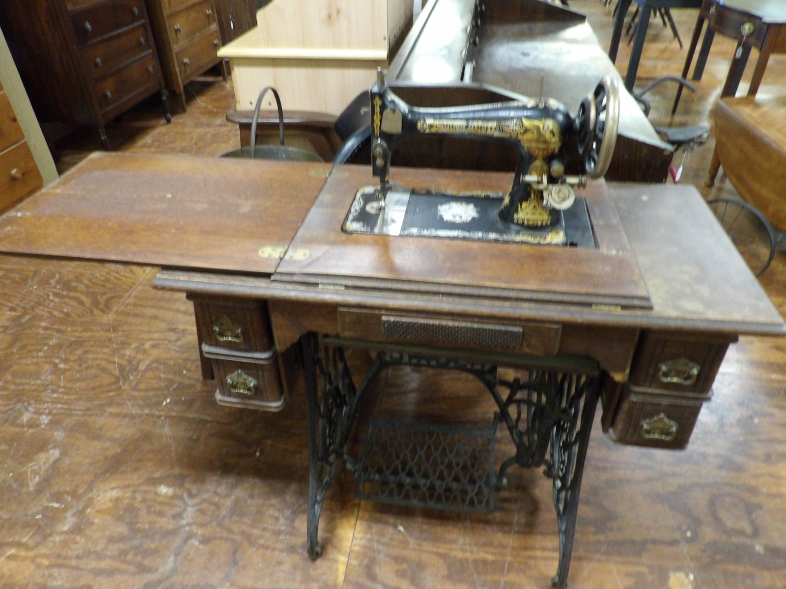 Vintage Singer Sewing Machine: Vintage Singer Sewing Machine in an Oak Cabinet with Cast Iron Treadle Base. Has original 1904 Owner's Manual. All measurements approximate. Please see photos for condition and details. Selling as is