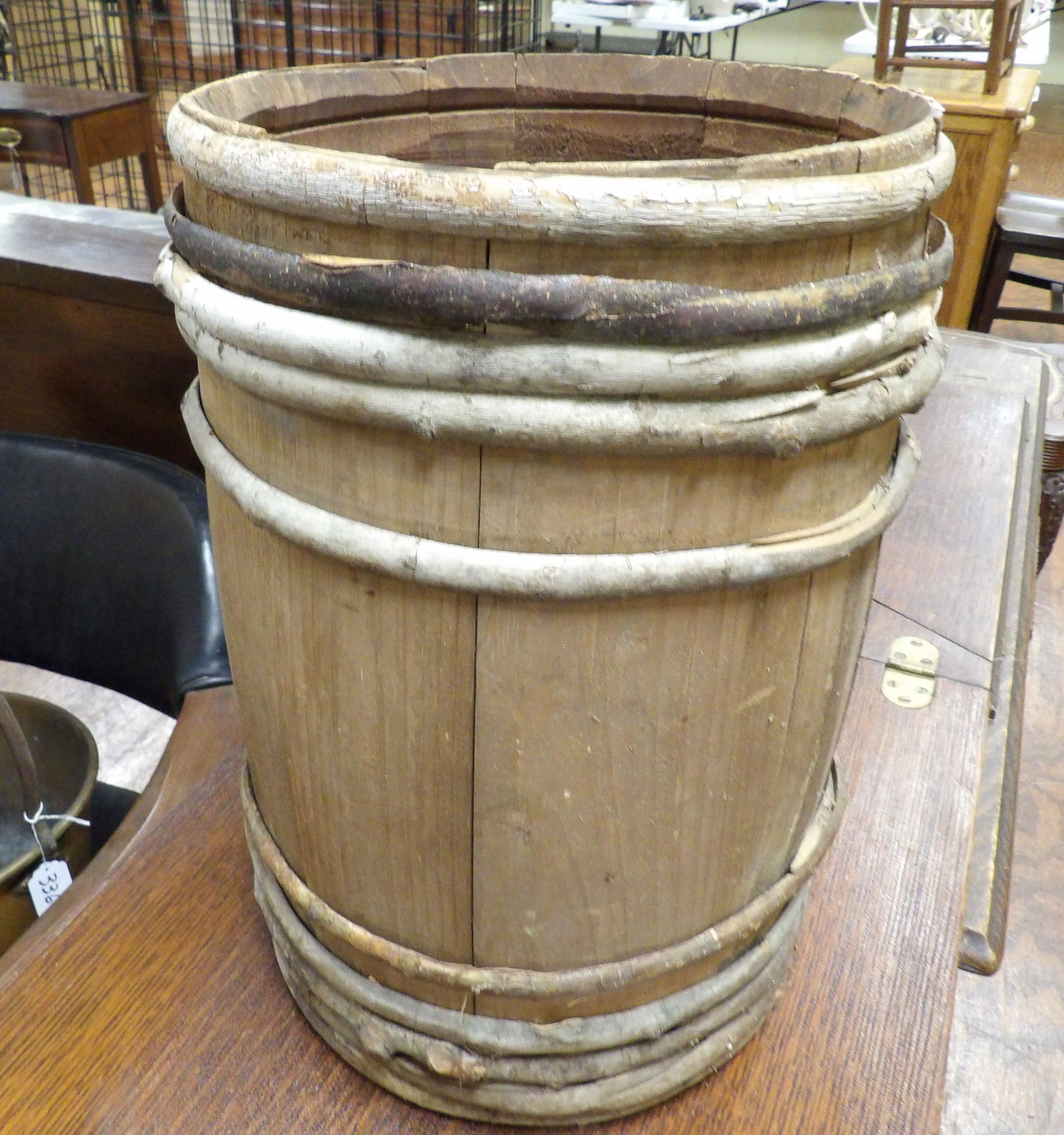 Primitive Staved Barrel: Primitive Antique Wooden Staved Barrel with Wooden Branch Hoops. 15" High X 10" Diameter. All measurements approximate. Please see photos for condition and details. Selling as is from 04281.