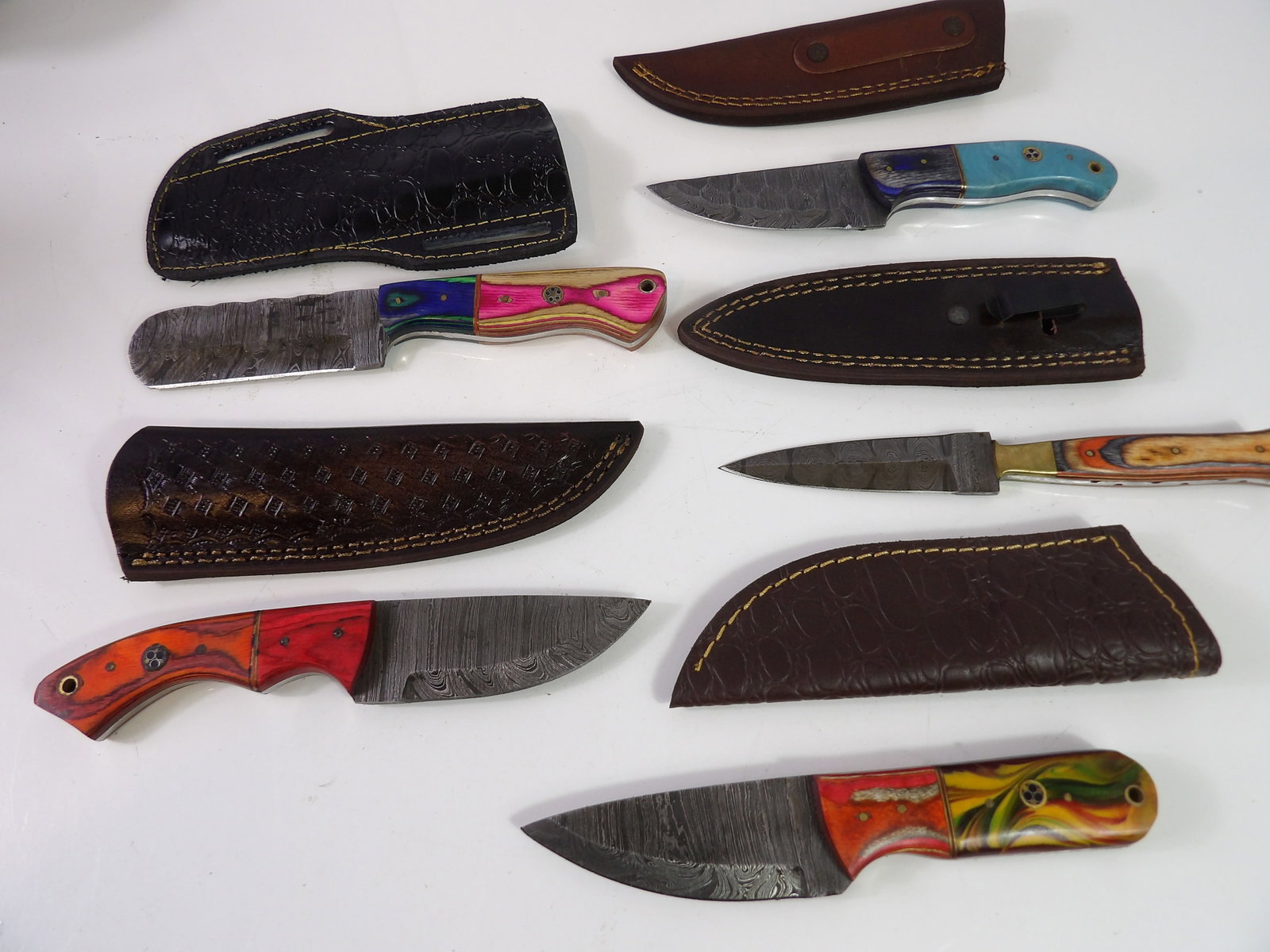 5 Handmade Damascus Steel Knives With Sheaths: Lot of 5 New Handmade Damascus Steel Knives with Leather Sheaths. All measurements approximate. Please see photos for condition and details. Selling as is from 04281.