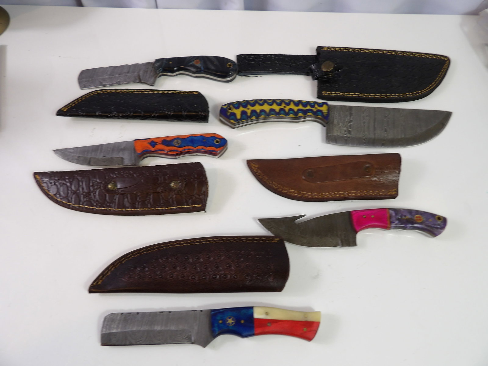 5 Handmade Damascus Steel Knives With Sheaths: Lot of 5 New Handmade Damascus Steel Knives with Leather Sheaths. All measurements approximate. Please see photos for condition and details. Selling as is from 04281.