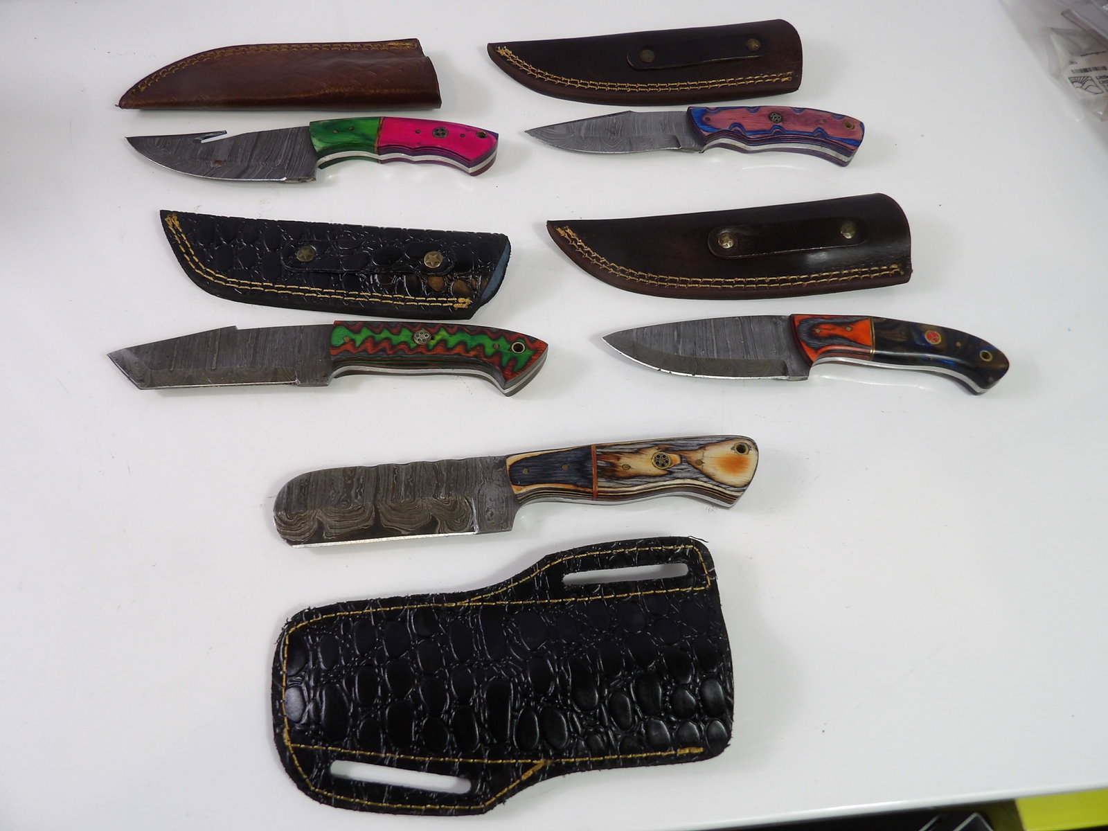 5 Handmade Damascus Steel Knives With Sheaths: Lot of 5 New Handmade Damascus Steel Knives with Leather Sheaths. All measurements approximate. Please see photos for condition and details. Selling as is from 04281.