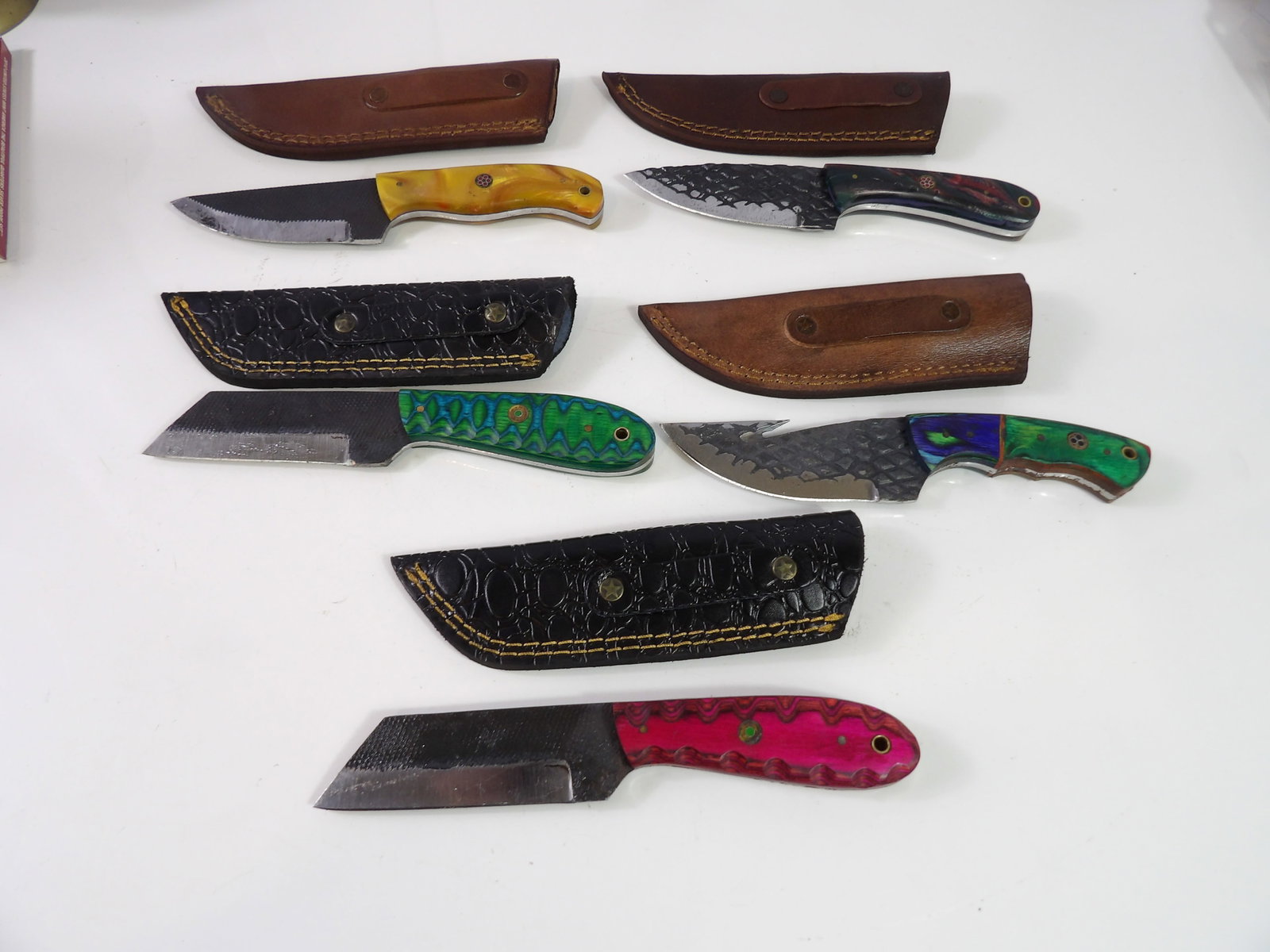 5 Handmade Damascus Steel Knives with Sheaths: Lot of 5 New Handmade Damascus Steel Knives with Leather Sheaths. All measurements approximate. Please see photos for condition and details. Selling as is from 04281.