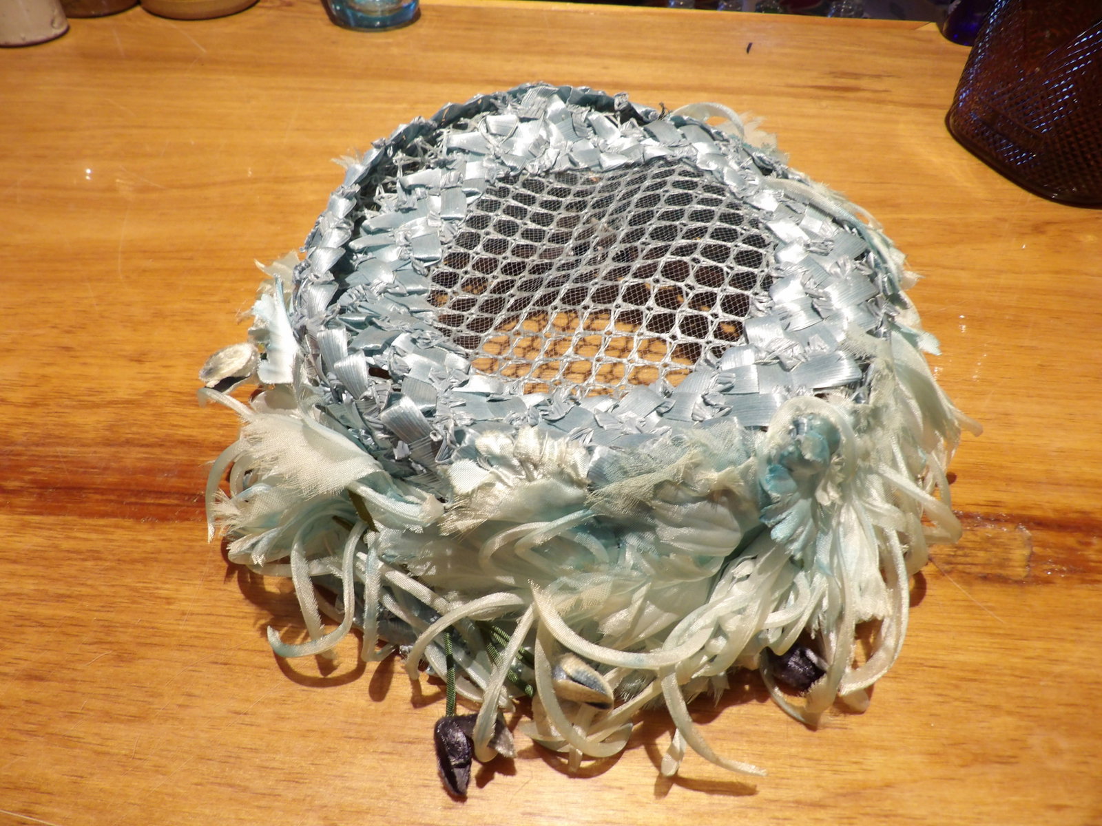 Vintage 1950's Blue Pillbox Hat: Vintage 50's Blue Woven Ribbon and Net Pillbox Hat with Floral Accents. All measurements approximate. Please see photos for condition and details. Selling as is from 04281.