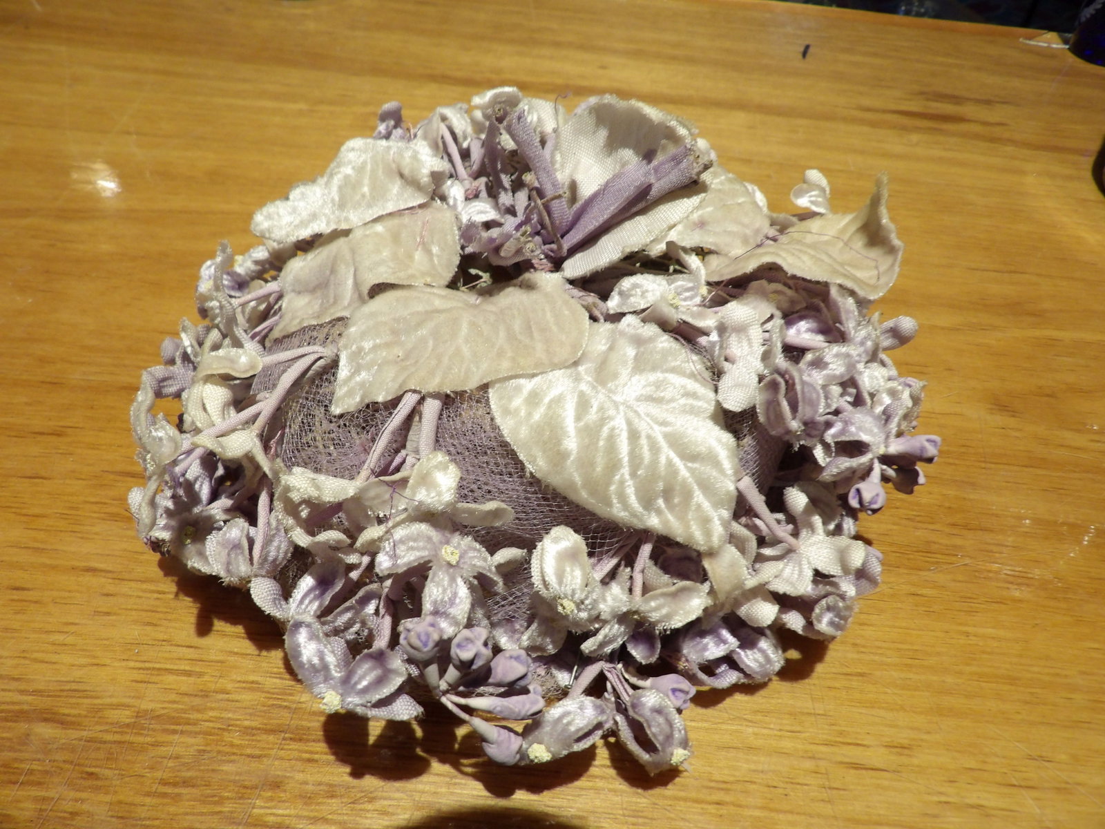 Vintage Purple Floral Hat with Face Veil: Vintage Purple Floral Hat with Net Face Veil and Velvet Leaves and Flowers. All measurements approximate. Please see photos for condition and details. Selling as is from 04281.