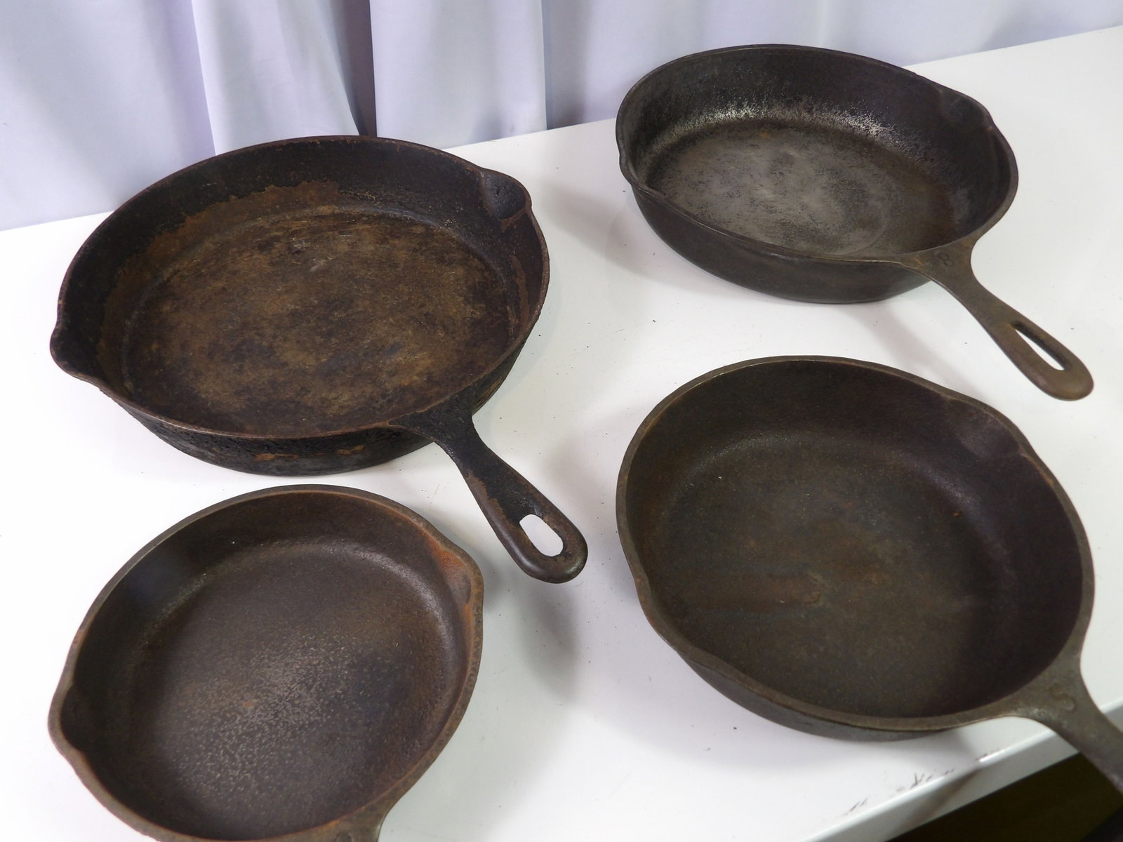 4 PCS.- Set of Frying Pans: Set of 4 Cast Iron Frying Pans. 2- #8's, 1- #3, 1= #5. All Made in U.S.A. All measurements approximate. Please see photos for condition and details. Selling as is from 04281.