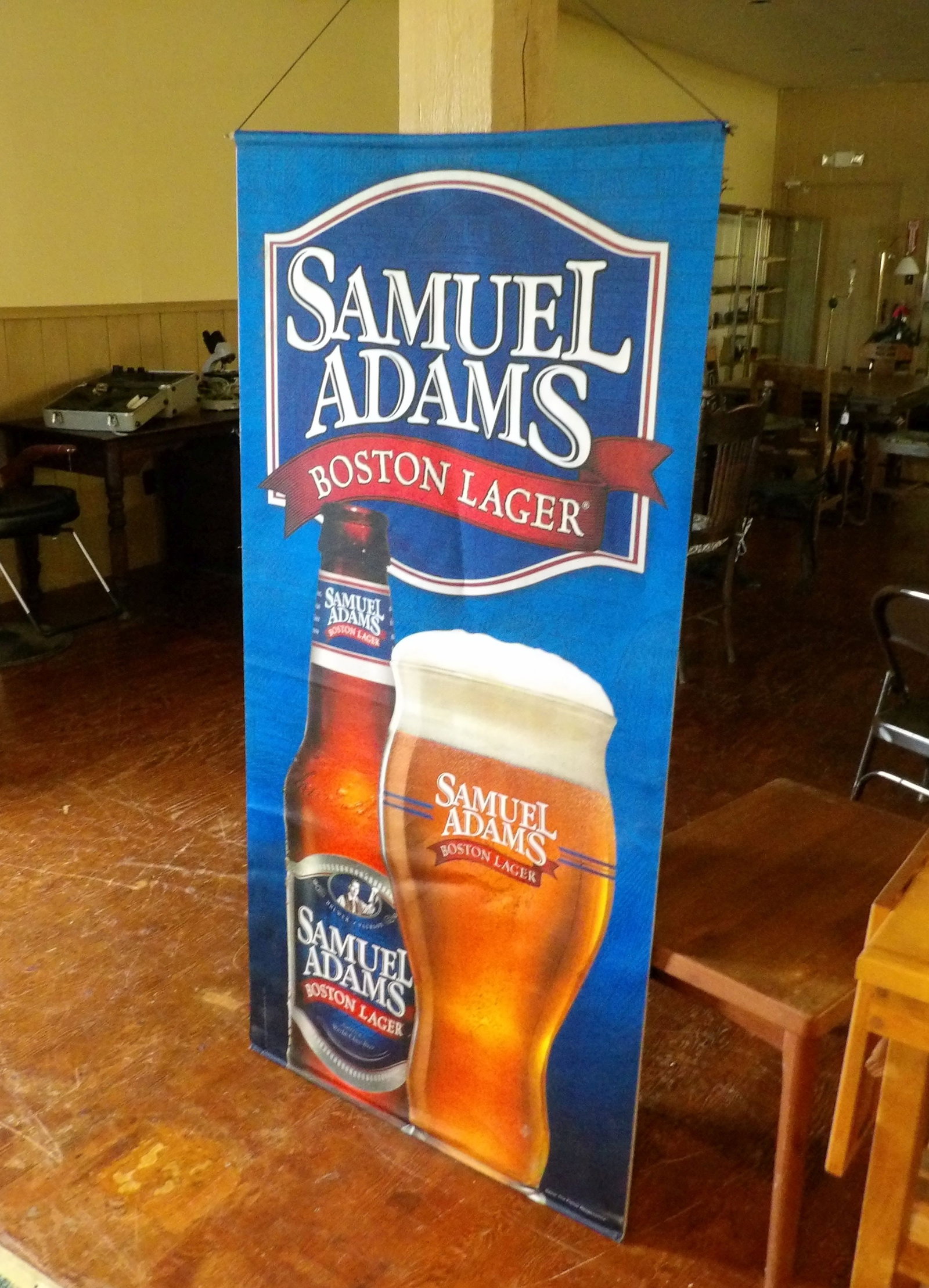 Sam Adams Beer Advertising Banner: 30" X 60" Sam Adams Beer Advertising Banner. Two Sided. All measurements approximate. Please see photos for condition and details. Selling as is from 04281.