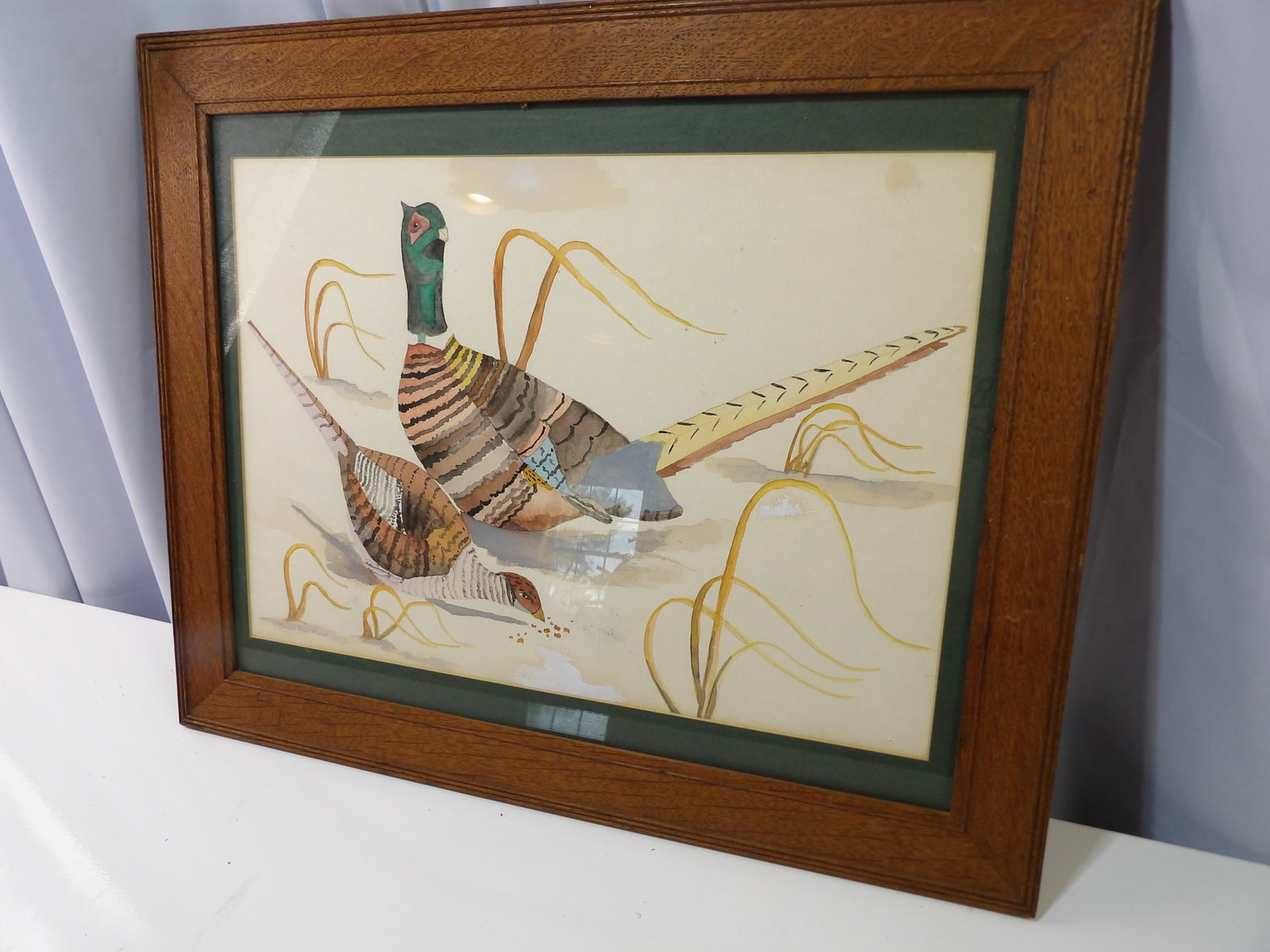 Vintage Oak Framed Watercolor Painting of Pheasants: Vintage Oak Framed Watercolor Painting of Two Pheasants in a Field. All measurements approximate. Please see photos for condition and details. Selling as is from 04281.