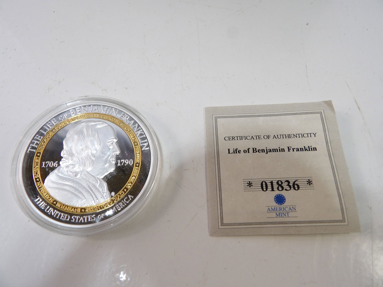American Mint Commemorative Coin, The Life of Benjamin Franklin: American Mint "The Life of Benjamin Franklin" Commemorative Coin with C.O.A. All measurements approximate. Please see photos for condition and details. Selling as is from 04281.