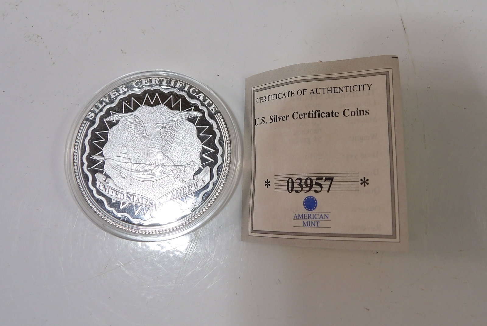 American Mint U.S. Silver Certificate Coin: American Mint U.S. Silver Certificate Coin. With Certificate of Authenticity. All measurements approximate. Please see photos for condition and details. Selling as is from 04281.