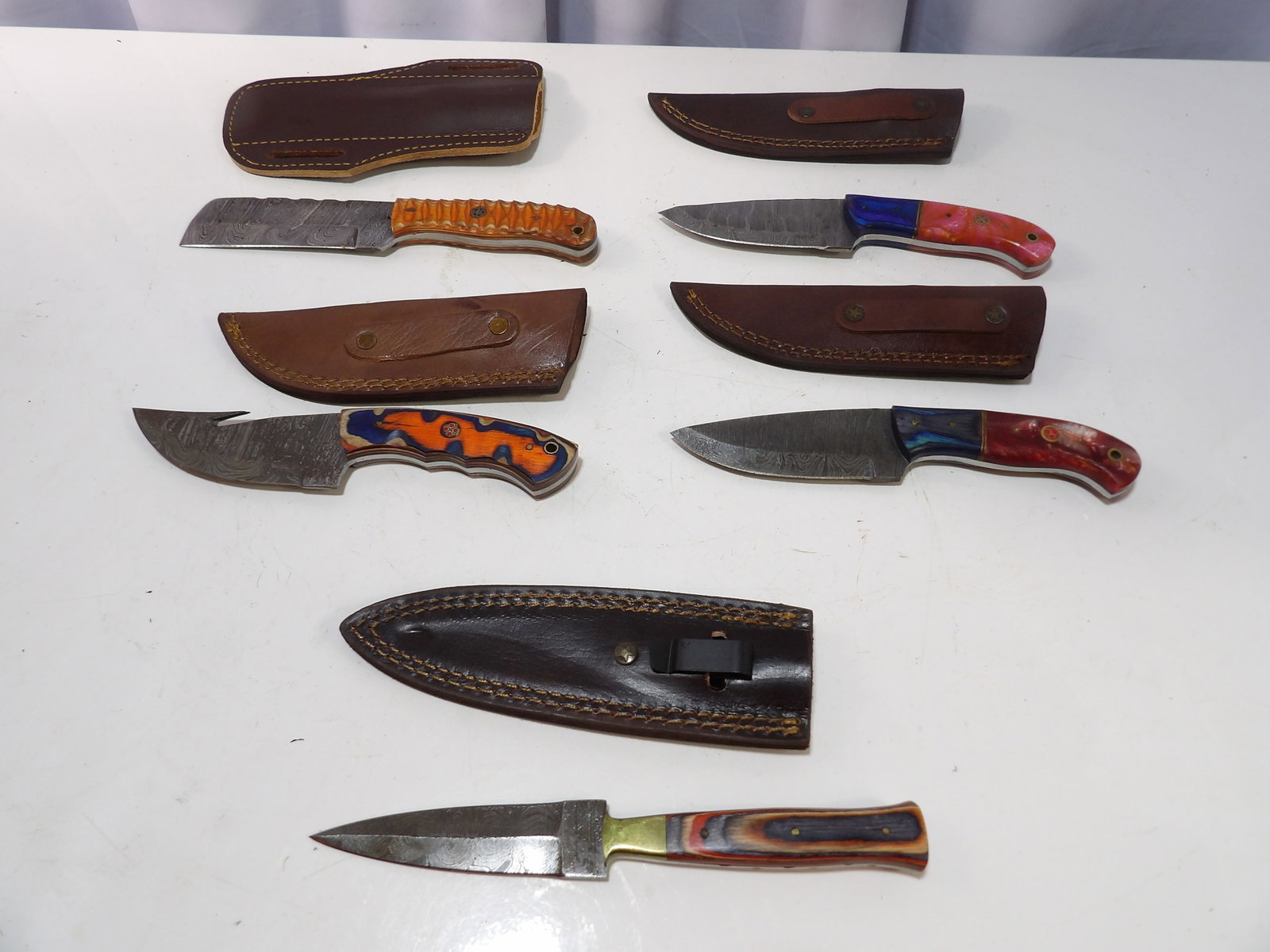 Lot of 5 Handmade Damascus Steel Blades with Sheaths: Lot of 5 New Handmade Damascus Steel Blades with Leather Sheaths. All measurements approximate. Please see photos for condition and details. Selling as is from 04281.