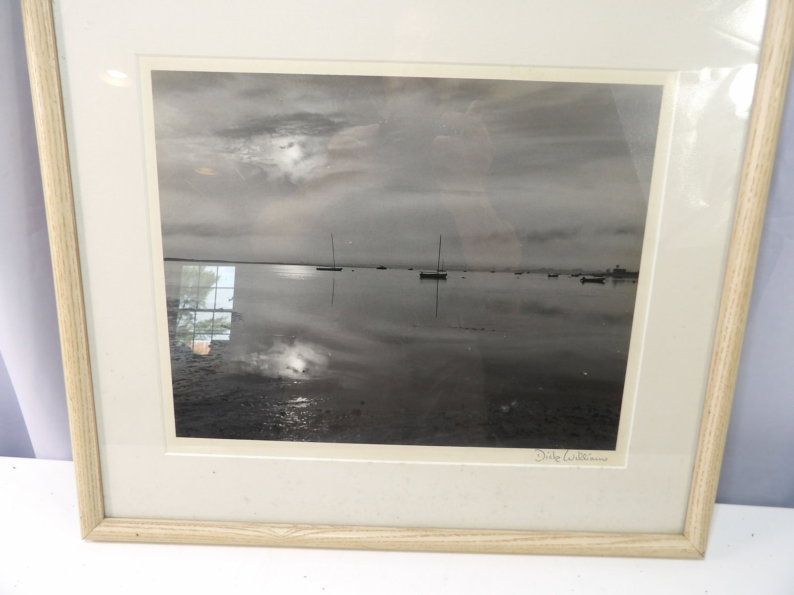Signed Black and White Photographic Print, Boat in Harbor by Dick Williams: Signed Black and White Photographic Print of Boat in Harbor by Dick Williams. All measurements approximate. Please see photos for condition and details. Selling as is from 04281.