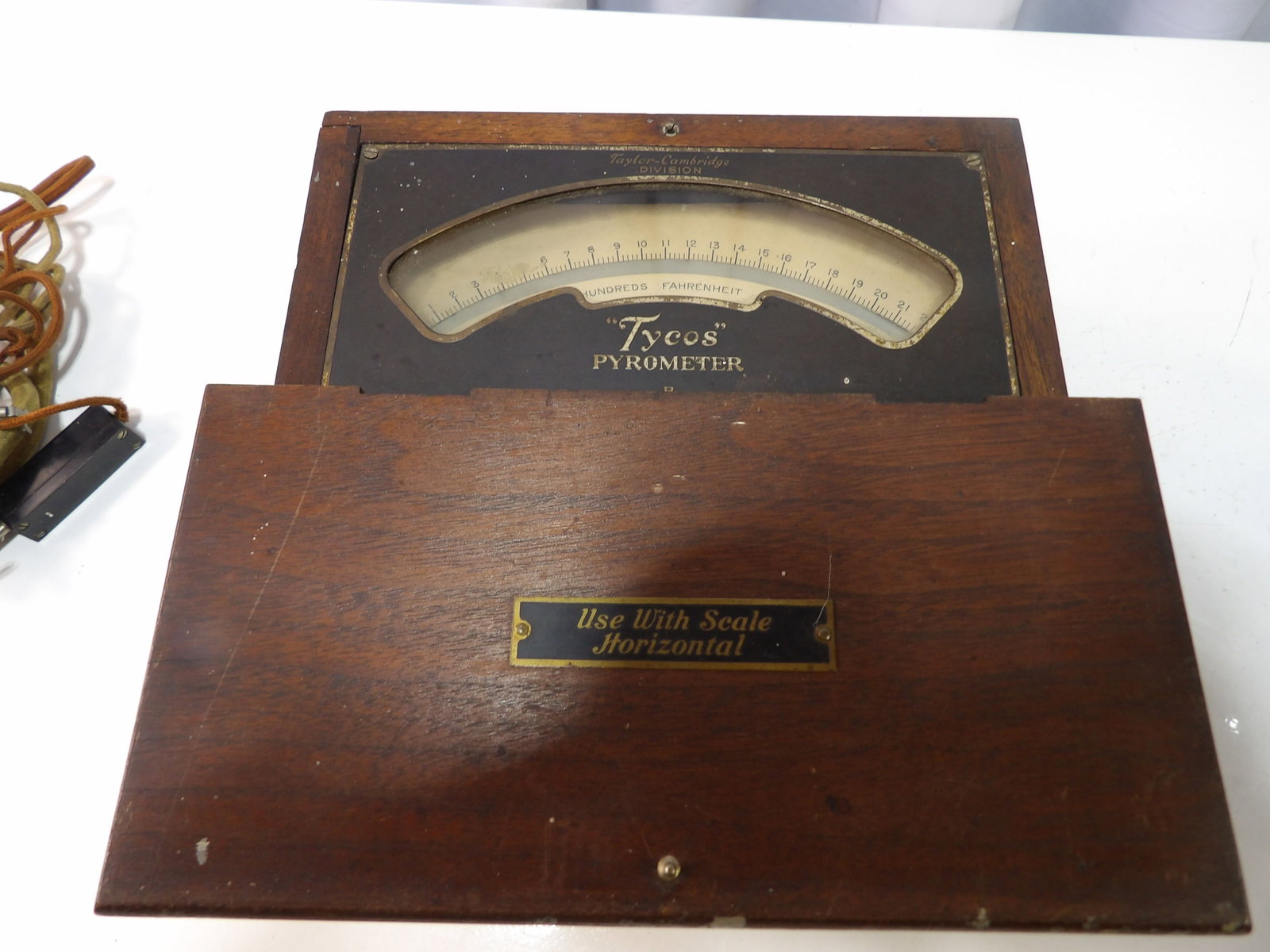 Vintage Tycos Pyrometer by Taylor-Cambridge: Vintage Tycos Pyrometer by Taylor-Cambridge Division in Wooden Case. All measurements approximate. Please see photos for condition and details. Selling as is from 04281.