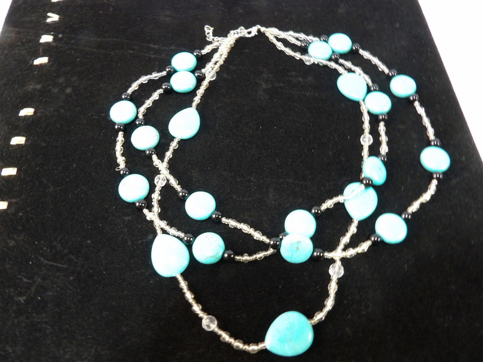 Multi Strand Necklace with Turquoise Colored Beads: Multi-Strand Necklace with Turquoise Colored Flat and Oval Beads and Clear Beads. All measurements approximate. Please see photos for condition and details. Selling as is from 04281.
