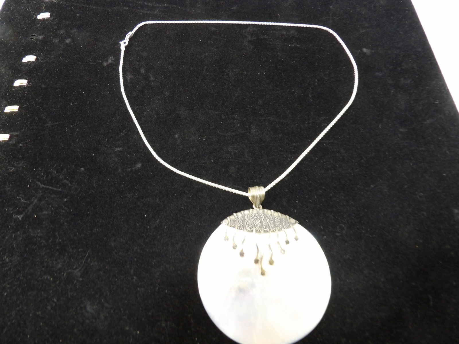 Mother of Pearl Necklace: Mother of Pearl Pendant in Sterling Silver. All measurements approximate. Please see photos for condition and details. Selling as is from 04281.