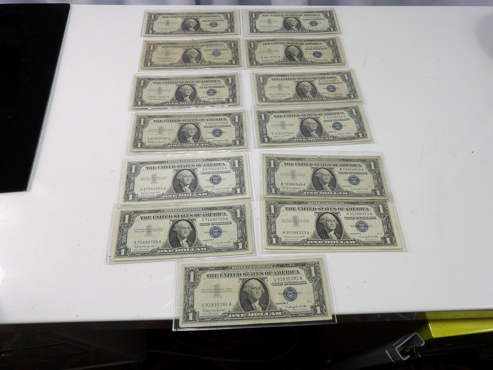 Collection of Silver Certificates, 12 from 1957, 1 from 1935: 13 Silver Certificates, 12 from 1957 and 1 from 1935. All measurements approximate. Please see photos for condition and details. Selling as is from 04281.