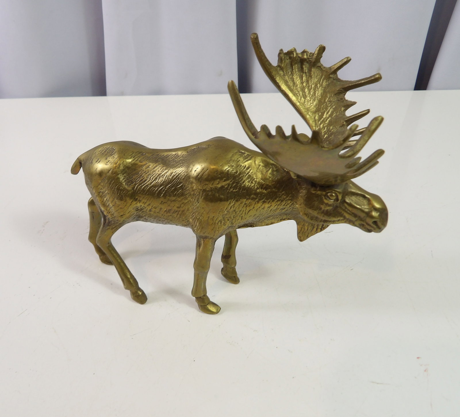 Brass Moose: Vintage Solid Brass Moose with Detailed Antlers, 5 1/2" tall by 7" long. All measurements approximate. Please see photos for condition and details. Selling as is from 04281.