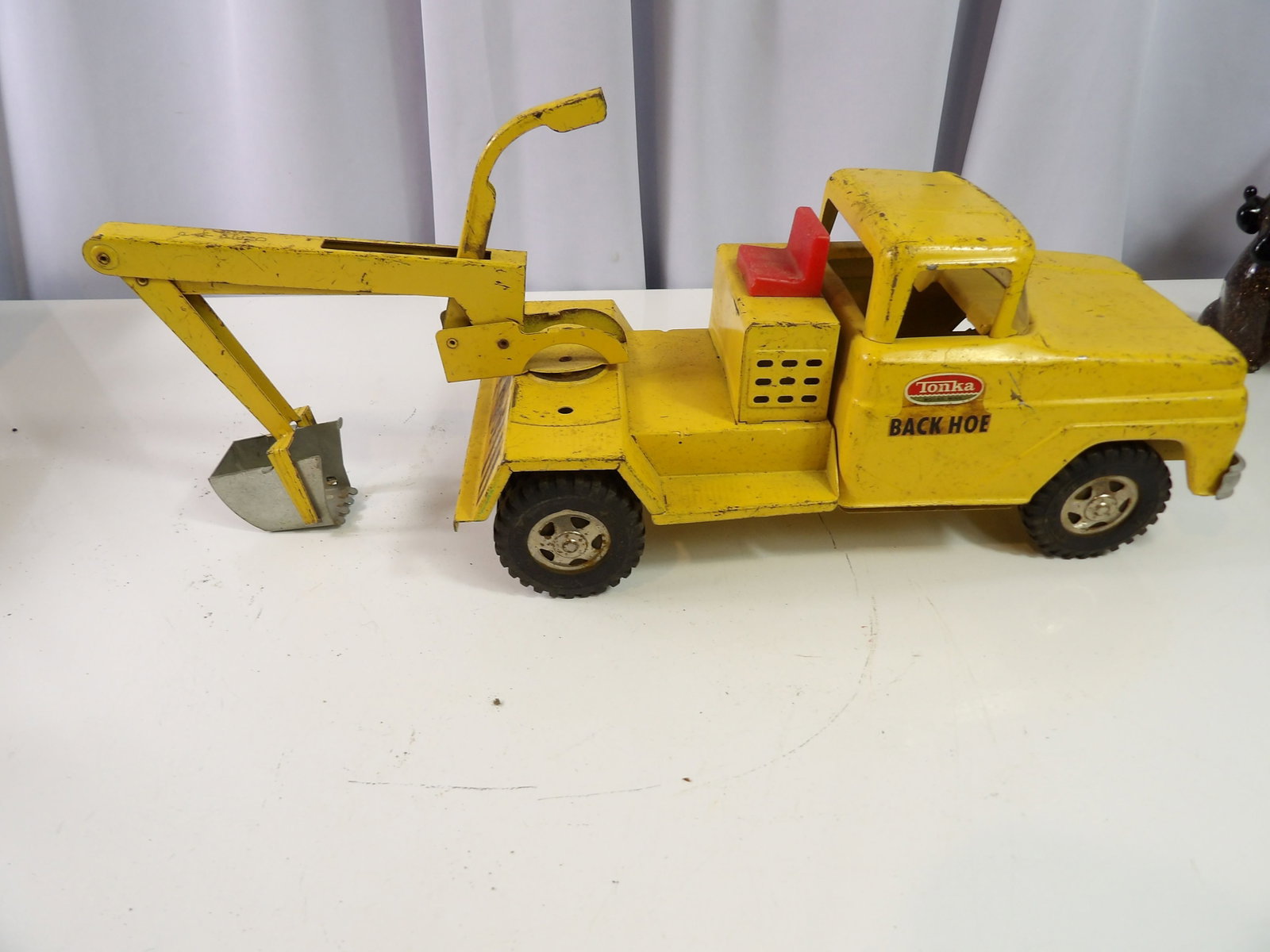 Tonka Backhoe: Vintage Tonka Backhoe Pressed steel truck, 18" long. All measurements approximate. Please see photos for condition and details. Selling as is from 04281.