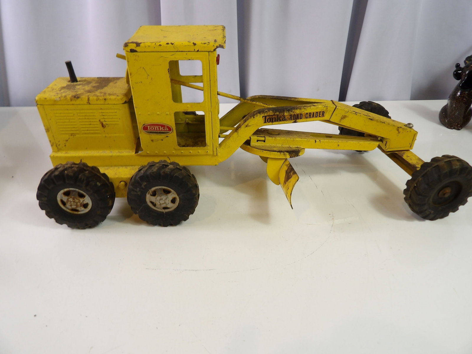 Tonka Road Grader: Vintage Tonka pressed steel yellow road Grader, 1960's, 18" long. All measurements approximate. Please see photos for condition and details. Selling as is from 04281.